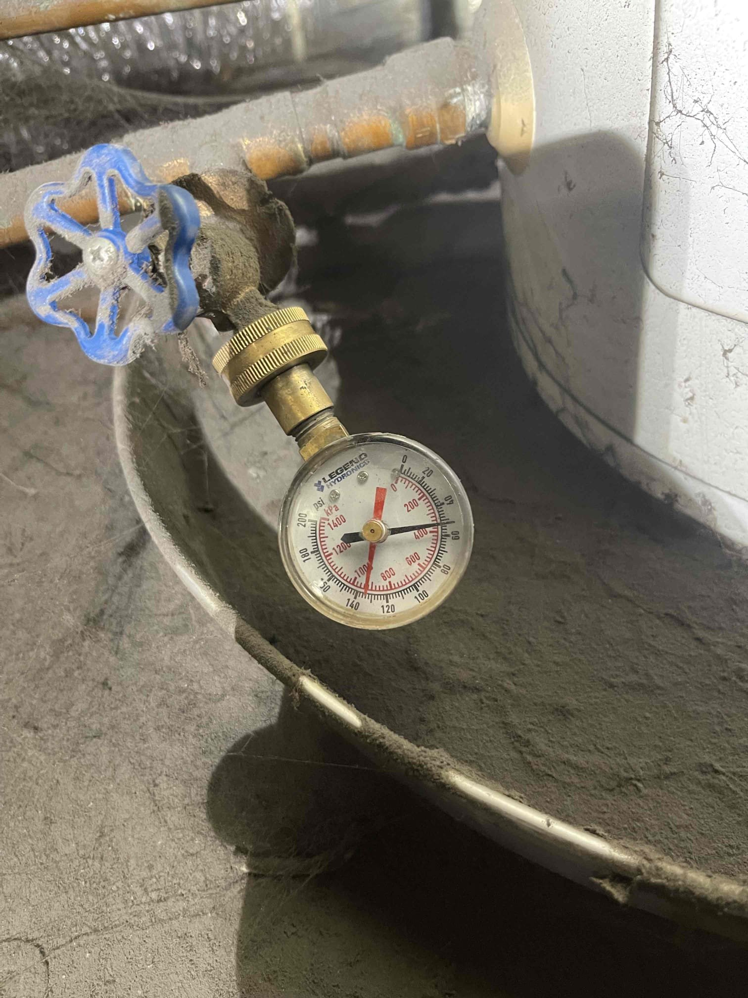 Came out for a leak in the ceiling of a warehouse. Building owner directed us to the men’s restroom ceiling in the warehouse. The tile was heavily saturated and collapsed as soon as I touched it. We looked in the ceiling and found a small water heater for the sinks. Went over to the women’s restroom to get closer to the tank. Examined tank and found it was still working, and there were no leaks. Water heater pan was dry and full of dust. T&p drain piping was cold to the touch. No sign of any plumbing leak. There was an exhaust fan pulling cold air from the inside restroom that is directly over the damaged ceiling tile. Believe this was condensating in the hot warehouse air and dripping onto the ceiling tile. 