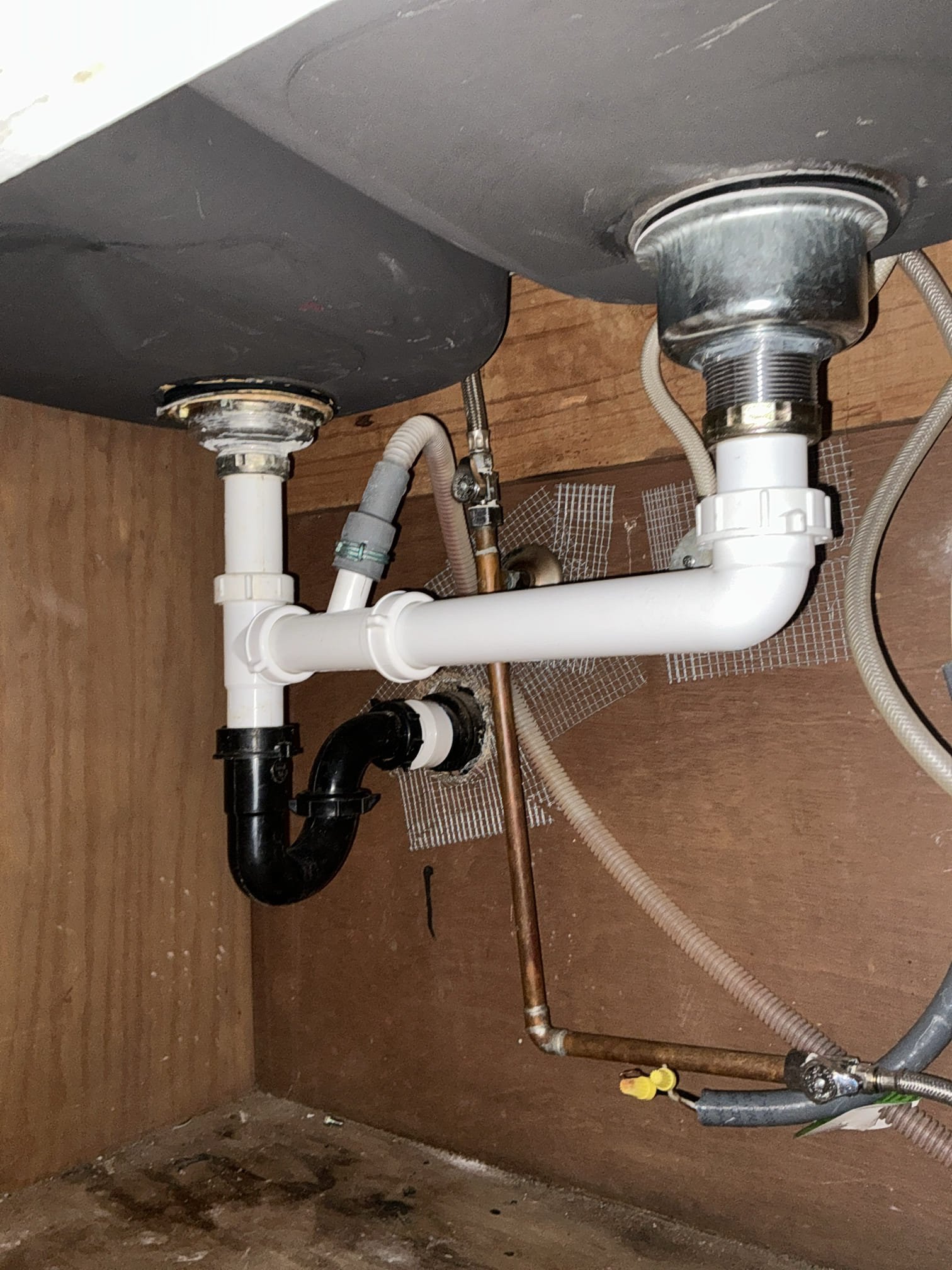 Diagnosed garbage disposal not working and sink backing up. Found disposal to be in rough shape and could not be unjammed. Removed garbage disposal and capped wires. Installed new basket strainer and new dishwasher tee. Connected all tubular drain underneath kitchen sink. Tested for proper operation and no leaks found after work completed.