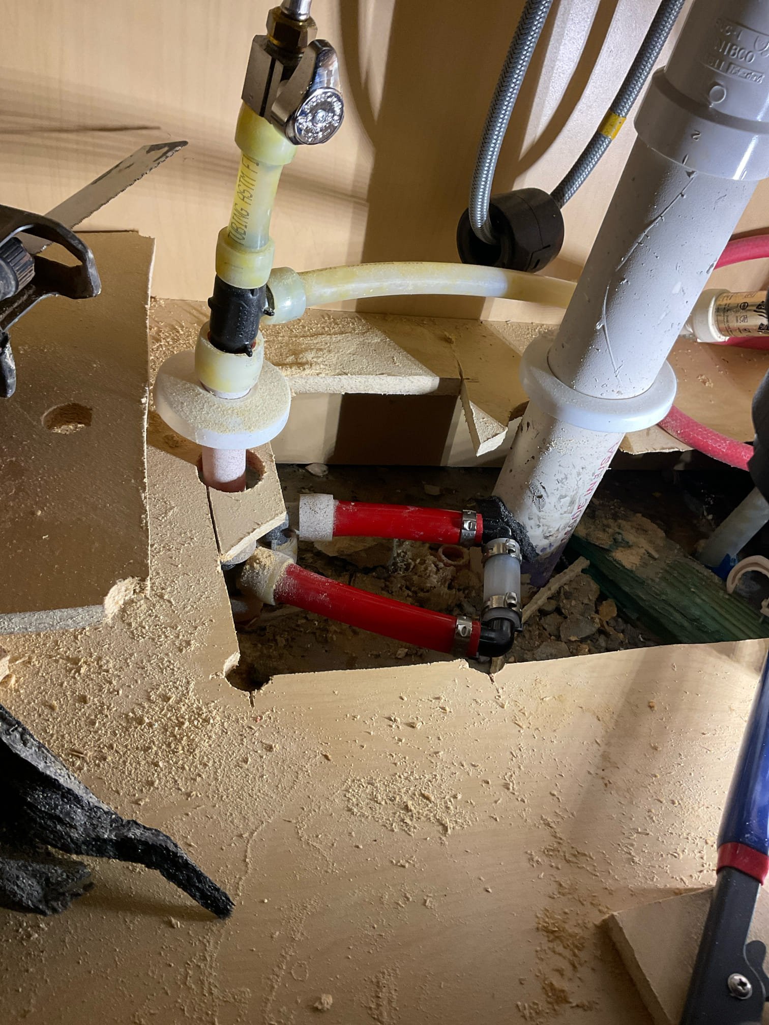 Customer stated that there was water coming through foundation wall by back patio. Took a look and found that kitchen was right next to the area. Looked under kitchen sink and felt warm air coming from holes where water lines were coming through. Made hole on bottom cabinet and found water there. Stated to customer that we need to cut an access hole at the bottom of the cabinet and see what is leaking and customer agreed. Cut cabinet and found pinhole leak on hot water line. Shut water off to home and made repair on waterline and turned water back on. Tested and no leaks were present at this time. Cleaned up work area. Also referred provision.