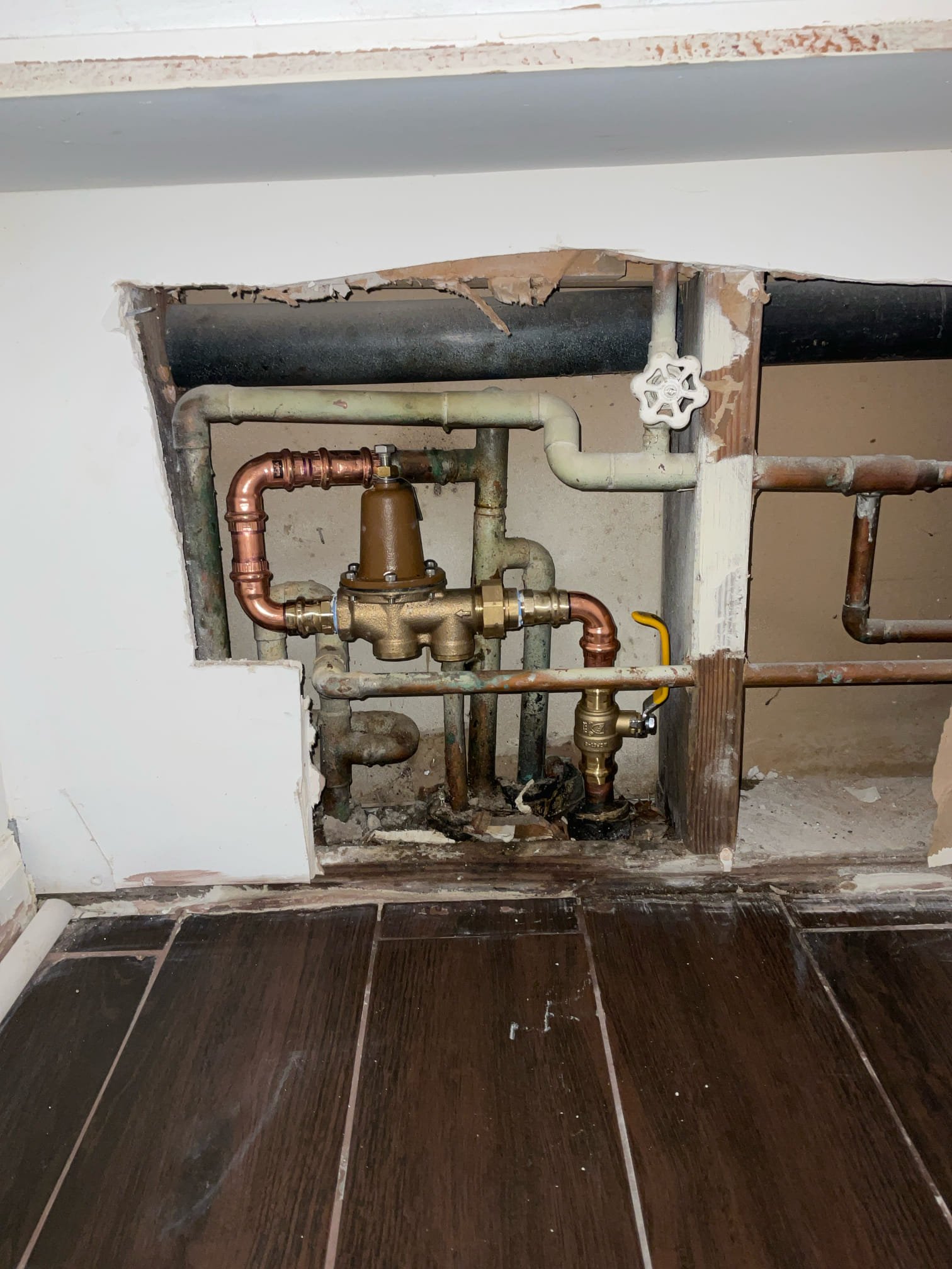 Customer stated that there was a wet spot in garage closet. Took a look and determine that what spot is most likely not plumbing related. Also tested water pressure to home and found that water pressure was at 100 psi and also customer wanted rear hose bib replaced. Stated to customer that we recommend replacing PRV and replacing hose bib and customer agreed. Went ahead and shut water off to home and removed existing PRV and main house shut off valve. Furnish and installed new PRV and shut off valve. In master bath, cut into cabinet to attempt to access hose bib and given how house was built wasn’t able to access hose bib line. Recommended customer to install a shut off on hose bib and customer will do that. Turned water back on and tested for leaks, and no leaks were present at this time. Set water pressure to 65 psi and cleaned up work area. One year warranty.