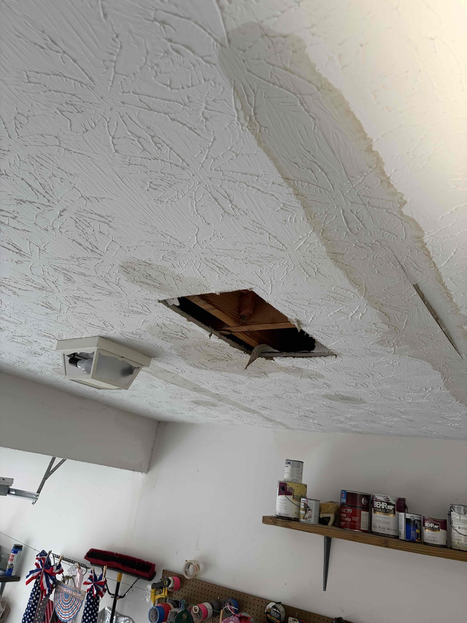 On arrival, customer states they’re experiencing a leak in garage. After inspection, noticed multiple water, stains, and dripping coming from garage ceiling. Informed customer we need to cut hole, to attempt to find leak. Customer approved, cut hole in garage, found leak coming from half inch gray polybutylene pipe feeding toilet. Provide a customer estimate to repair leak, customer approved estimate. Cut out pinhole, installed new half-inch pegs with new straight stop and supply line. No leaks at departure.