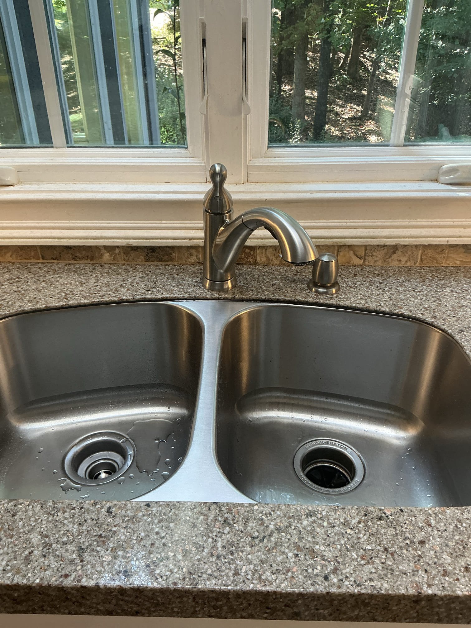 Diagnosed leak underneath kitchen sink. Found faucet to be leaking and following pipes down. Leaking on base and soaking wood area holding faucet. Shut off water to home, removed old kitchen faucet, installed new kitchen faucet and as a courtesy replaced both hot and cold shut off valves. Tested new faucet for proper operation. No leaks found from faucet. Also noticed since wood below is still soaked, may be some residual water that drips down as it drys out. Also sealed counter to sink to not allow any water into cabinet below. 

Customer did not want me to check heater and water pressure today