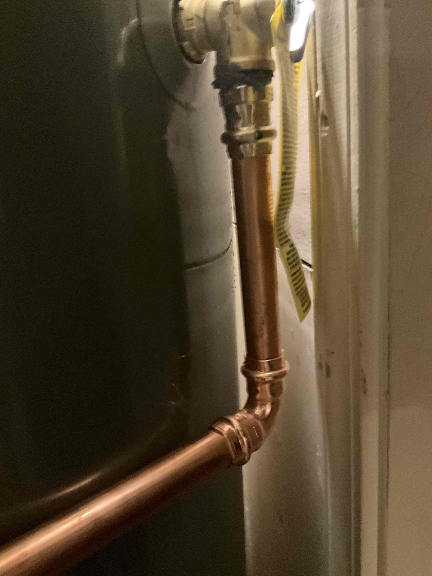 Upon arrival, the customer reported a leaking pipe near the water heater. After performing an evaluation, I identified an active leak at the existing pressure-reducing valve (PRV) and confirmed that the water heater was also leaking. The existing water heater was approximately 16 years old and required replacement. I explained my findings to the customer and recommended replacing both the water heater and the leaking PRV. I also recommended replacing the main water shut-off valve and making the necessary installation upgrades to bring the water heater system into compliance with applicable plumbing codes. The proposed work included installing a new thermal expansion tank secured with a mounting bracket, placing the new water heater inside a metal drain pan, and installing a new PRV and whole-home shut-off valve. The customer reviewed and approved the estimate. I removed the existing water heater and leaking PRV. I then installed a new 40-gallon tall natural gas water heater, a new ther