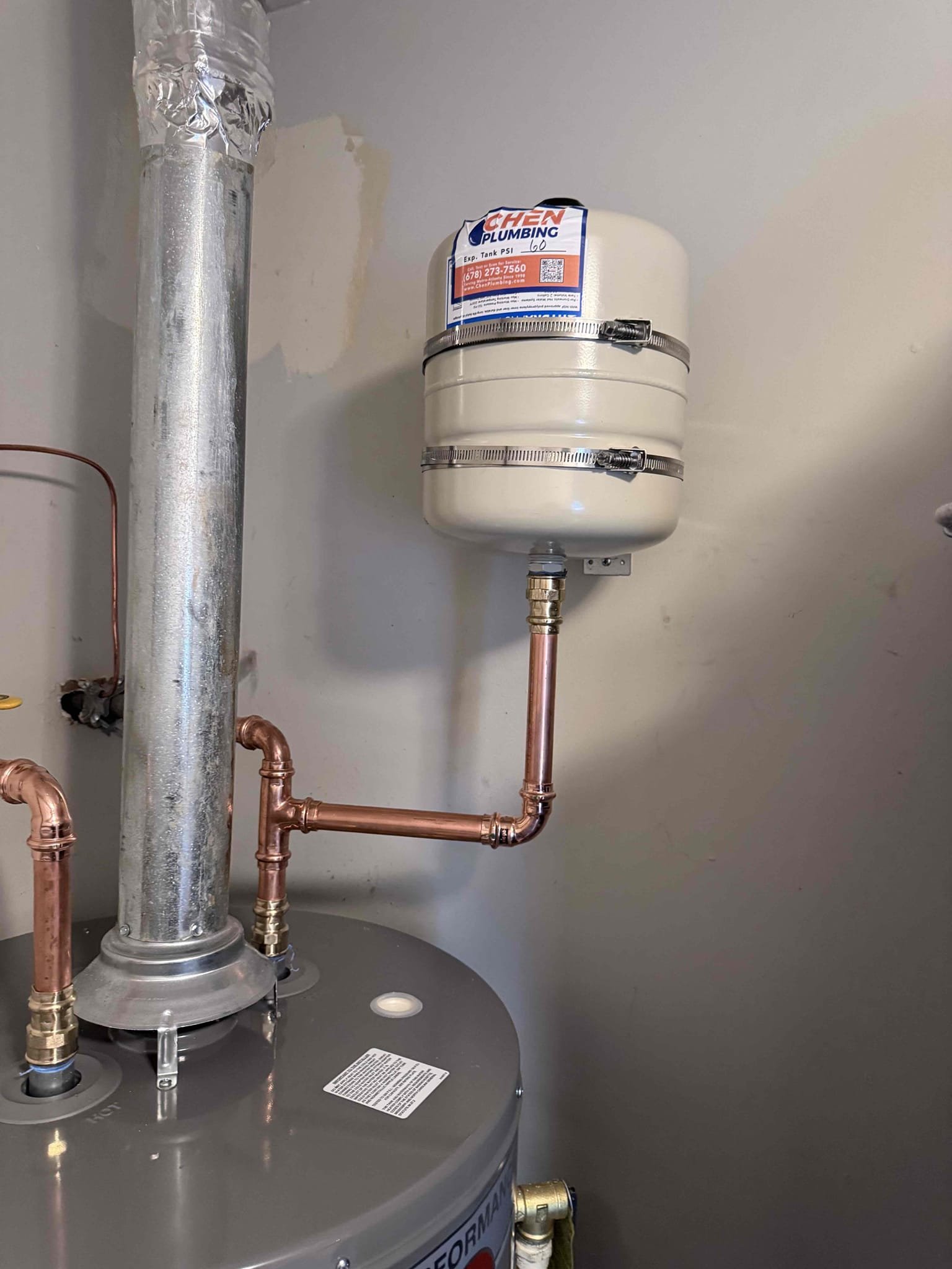 Returned to the customer’s home to remove and replace the existing 50-gallon gas water heater. Shut off the necessary water and gas supplies, then disconnected and removed the existing water heater. Installed the new 50-gallon gas water heater in the existing drain pan and reconnected it to the existing plumbing and gas connections.
Reinstalled and secured the thermal expansion tank using a mounting bracket to ensure proper support. Once the installation was complete, restored the water supply to the water heater and bled air from the plumbing system by allowing the air to purge through the fixtures. After confirming the tank was full of water, restored the gas supply and lit the water heater according to the manufacturer’s operating procedures. Adjusted the thermostat to 120°F.
Inspected the plumbing connections and water heater for leaks and verified proper operation. Confirmed that the water heater was functioning correctly and that no leaks were present at the time of departure.