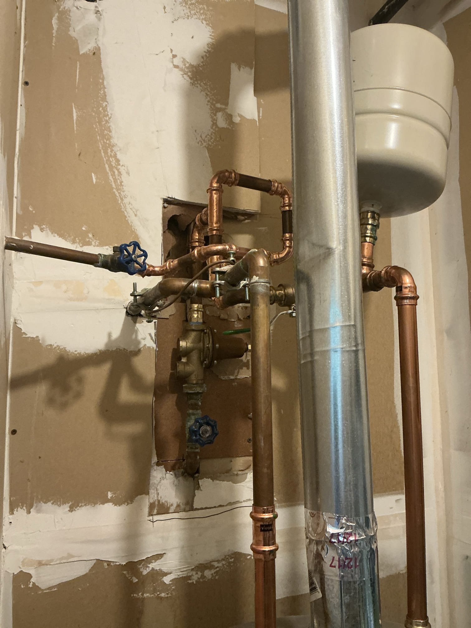 Diagnosed loud banging noise near water heater. Found old pressure regulator failed causing loud water hammering. Shut off water to home and drained system. Cut out and removed old pressure regulator and some nearby pipe. Installed new regulator and reworked piping to adapt to new regulator. Set pressure to 65psi. No leaks found after work completed 