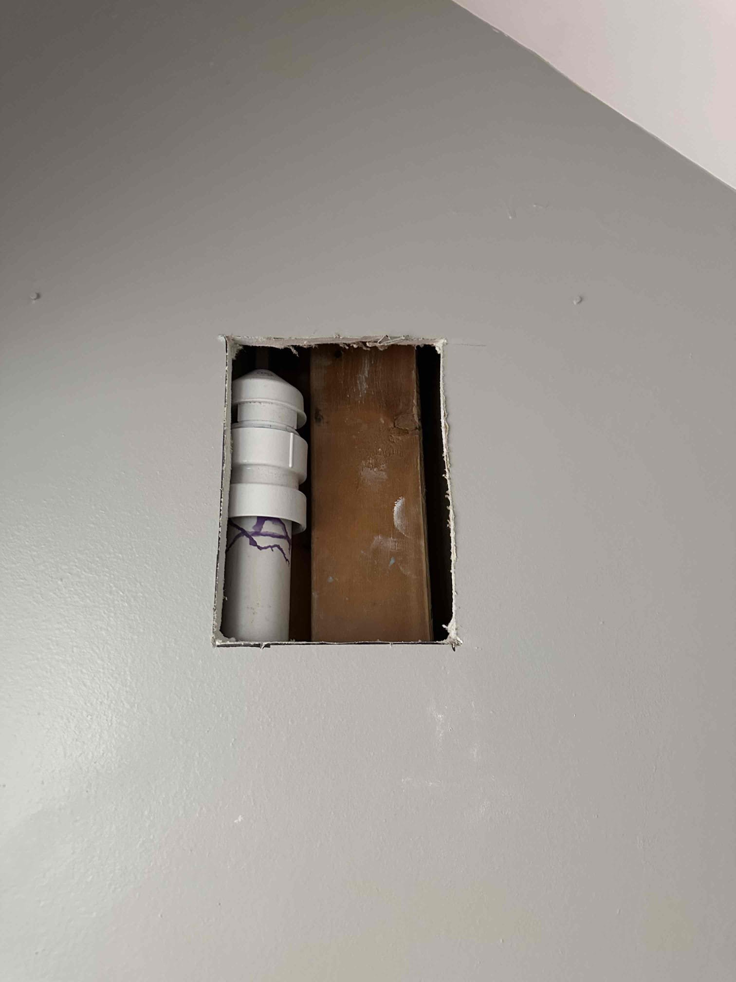Remove washer and dryer (double stacked). Turn off water to home and drain system. Use small hammer drill and carefully break up concrete around water and drain line exposed slightly below cracked concrete. Cut Sheetrock to expose drain and water lines. Cut and run hot and cold water lines to washer deeper than current state (right at top of concrete). Connect new lines to new washing machine box. Test for proper operation and leaks. After water lines have been addressed, run small camera through washing machine line to check for any obstruction or issues that cause drain to overflow with high volume of water. Possibly related to venting issue. Will add wall air admittance valve if needed.