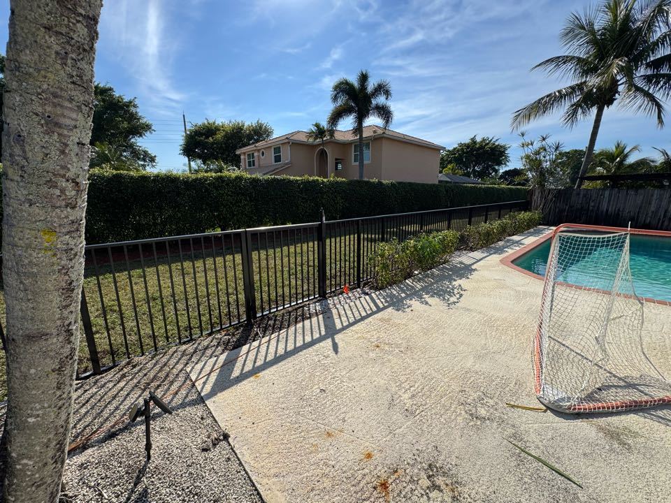 Boca Raton, FL - In West Boca, we replaced 60 feet of an old, weathered wood fence with 56 feet of sleek black aluminum fencing and a 4-foot-wide pool-code-compliant gate. This upgrade enhances durability, safety, and curb appeal while meeting all pool safety regulations. 