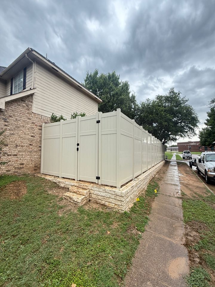Dallas, TX - Top Rail Fence just wrapped up a beautiful 8 foot tall vinyl fence in Cedar Hill. We worked alongside a Retaining Wall partner to ensure the top of the fence would look nice and level. If you’re looking for a low maintenance fence, give us a call at 817–8 03–3338