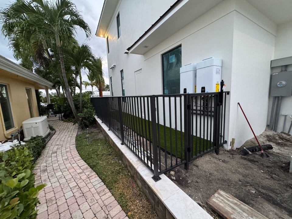 On Singer Island, we installed 160 linear feet of 4ft tall bronze aluminum fencing with two gates at a beautiful waterfront home. This pool barrier fence was completed for one of our luxury home builder partners and designed to meet all pool code requirements while maintaining a clean, upscale look that complements the property’s coastal setting.