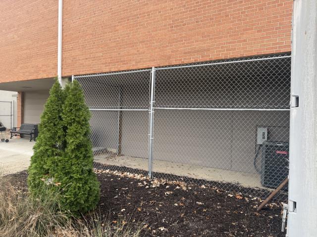 Kansas City, MO - Top Rail Fence was asked to raise the height of the existing chain-link fence to protect the building's HVAC system better. 