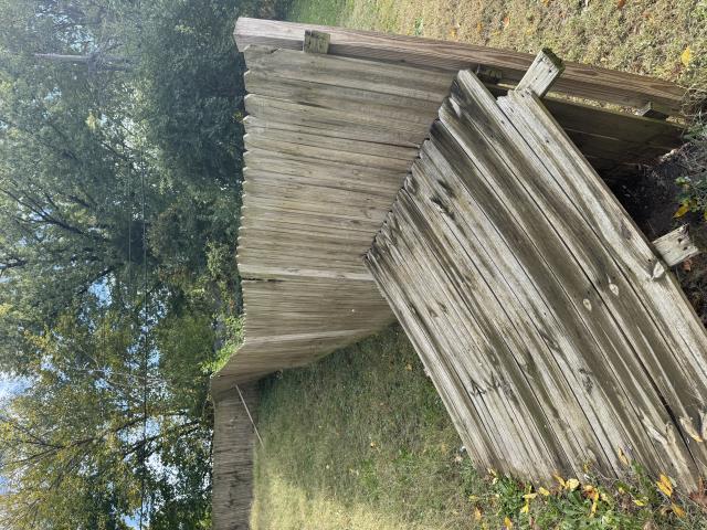 Kansas City, MO - Top Rail Fence was asked to repair this wood fence that has been falling into the neighbor's yard. 