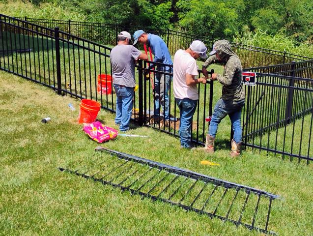 Kansas City, MO - Top Rail Fence installed a four-foot, flat-top, three-rail, black ornamental steel fence.