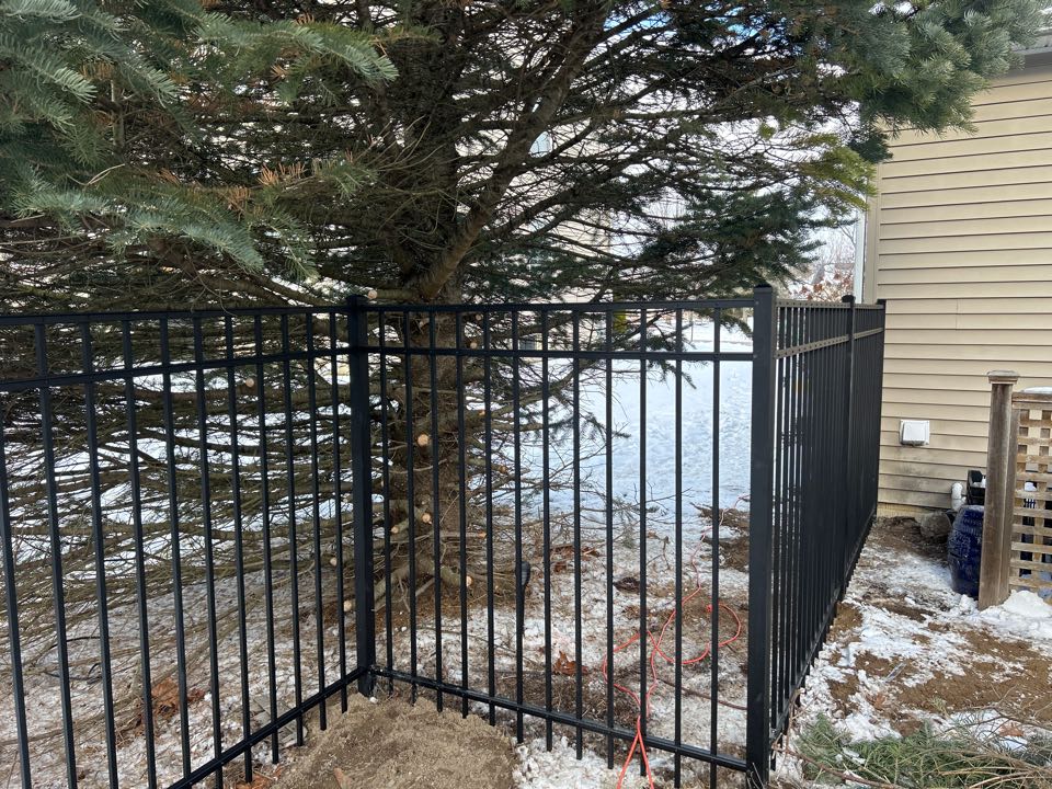 Dexter, MI - I recently completed a project for a client in Dexter, Michigan. The project involved building a 5-foot-high aluminum ornamental fence. The fence was designed to enhance the curb appeal of the client's home and provide privacy and security. The project required careful planning and execution to ensure that the fence was installed correctly and to the client's satisfaction.  To begin the project, I met with the client to discuss their preferences and requirements for the fence. We discussed the style, color, and materials they wanted for the fence. I then provided them with a detailed estimate of the cost and timeline for the project.  Once the estimate was approved, I began the construction process. I worked with a team of skilled laborers to install the fence. We started by digging the necessary holes for the posts and pouring the concrete footings. We then installed the posts and attached the fence panels to the posts.  The fence panels were made of high-quality aluminum and were pow