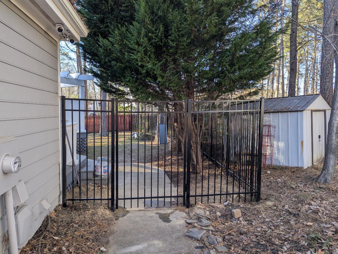 Cary, NC - A custom 6-foot-tall aluminum fence designed to keep a homeowner?s puppies safe and secure. This durable residential fencing solution provides peace of mind while enhancing the yard?s appearance?perfect for pet-friendly fencing in the Raleigh-Durham area, including Raleigh, Durham, Cary, and surrounding communities.