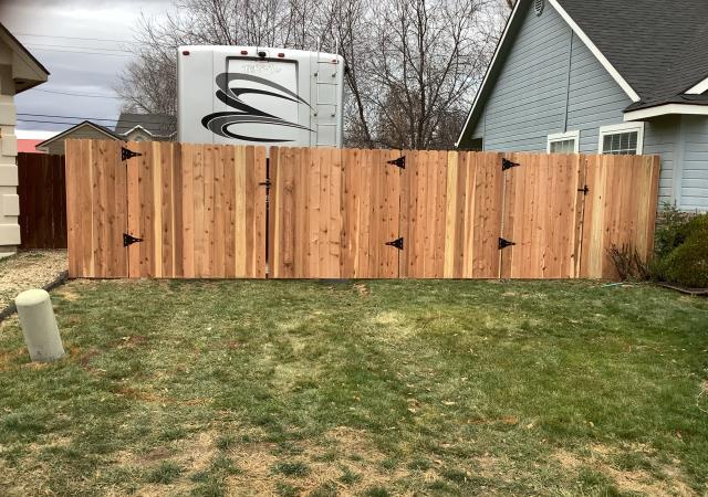 Nampa, ID - Recently installed a new cedar dog eared picket side fence and wing fence with a double and single gate to make it easier to back their camp trailer in. We use Steel posts, 3/4 inch thick pickets and 3 rails. Looks great! 