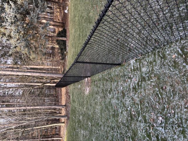 West Olive, MI - We installed a 4'H black chain link fence, securing HOA approval. Our team managed the permit, tree removal, brush clearing, and installation.