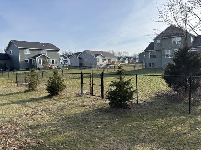 Holland, MI - We installed a 5'H black chain link fence, ensuring the homeowner's dog's safety and HOA approval. The warm weather allowed for efficient work, and two double drive gates were included.