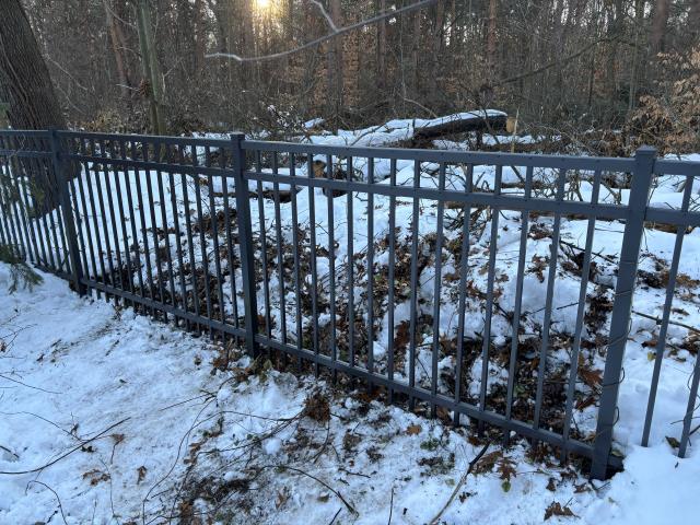 Saugatuck, MI - We repaired a damaged aluminum fence caused by a fallen tree. We replaced the damaged sections with new sections, restoring the fence's integrity and appearance.