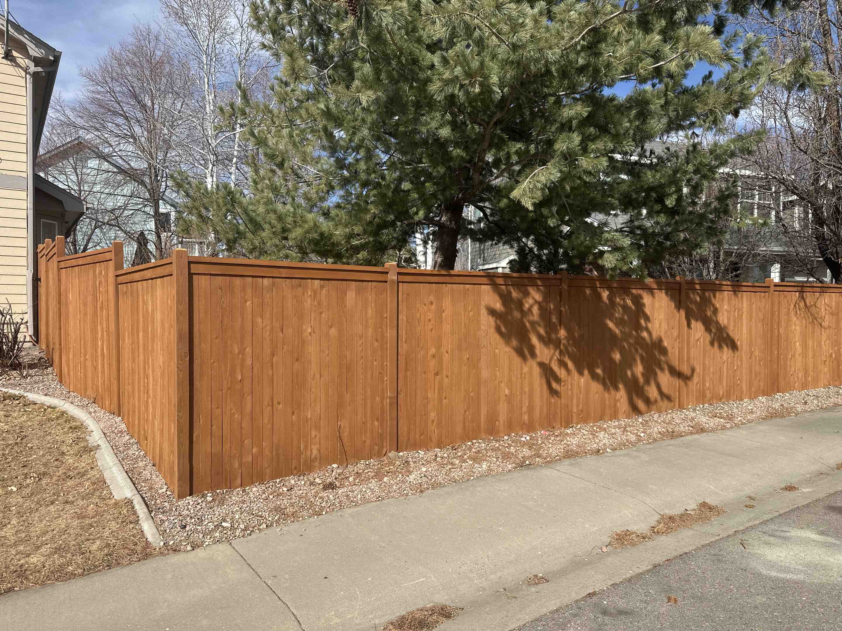Fort Collins, CO - Beautiful new cap and trim fence with exposed post and a natural cedar stain in Fort Collins, Colorado