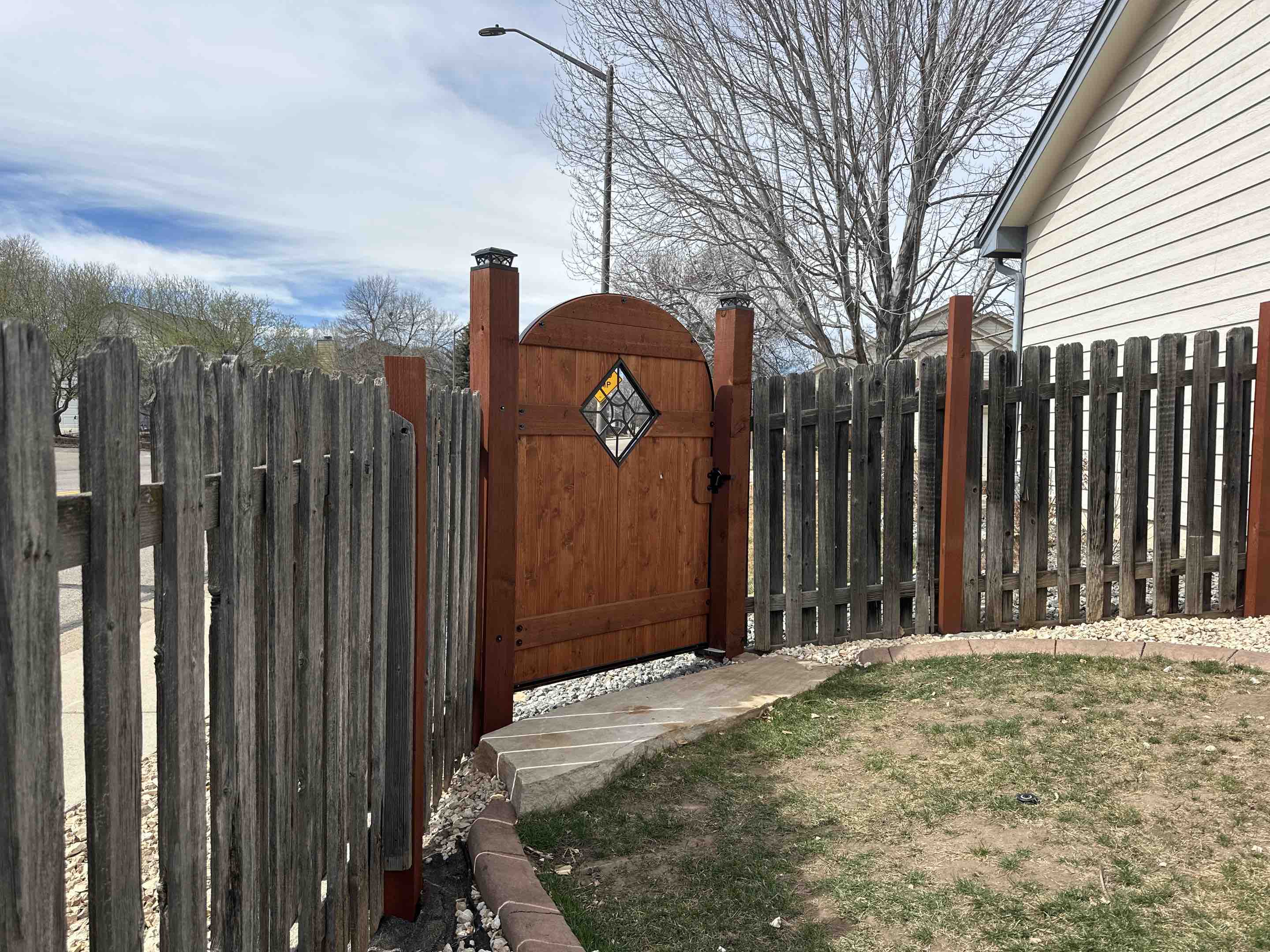 Fort Collins, CO - Beautiful new custom gate in Fort Collins, Colorado. With a center decorative cut out along with oversized post to provide a stable foundation for the gate. 