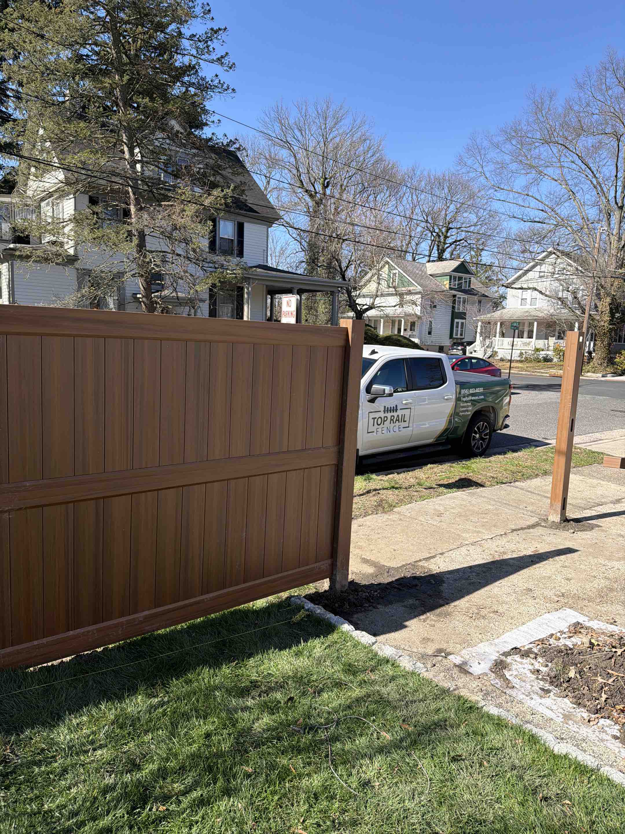Moorestown, NJ - Installing a beautiful mocha walnut vinyl fence system in Moorestown. This one will be a stunner once completed.