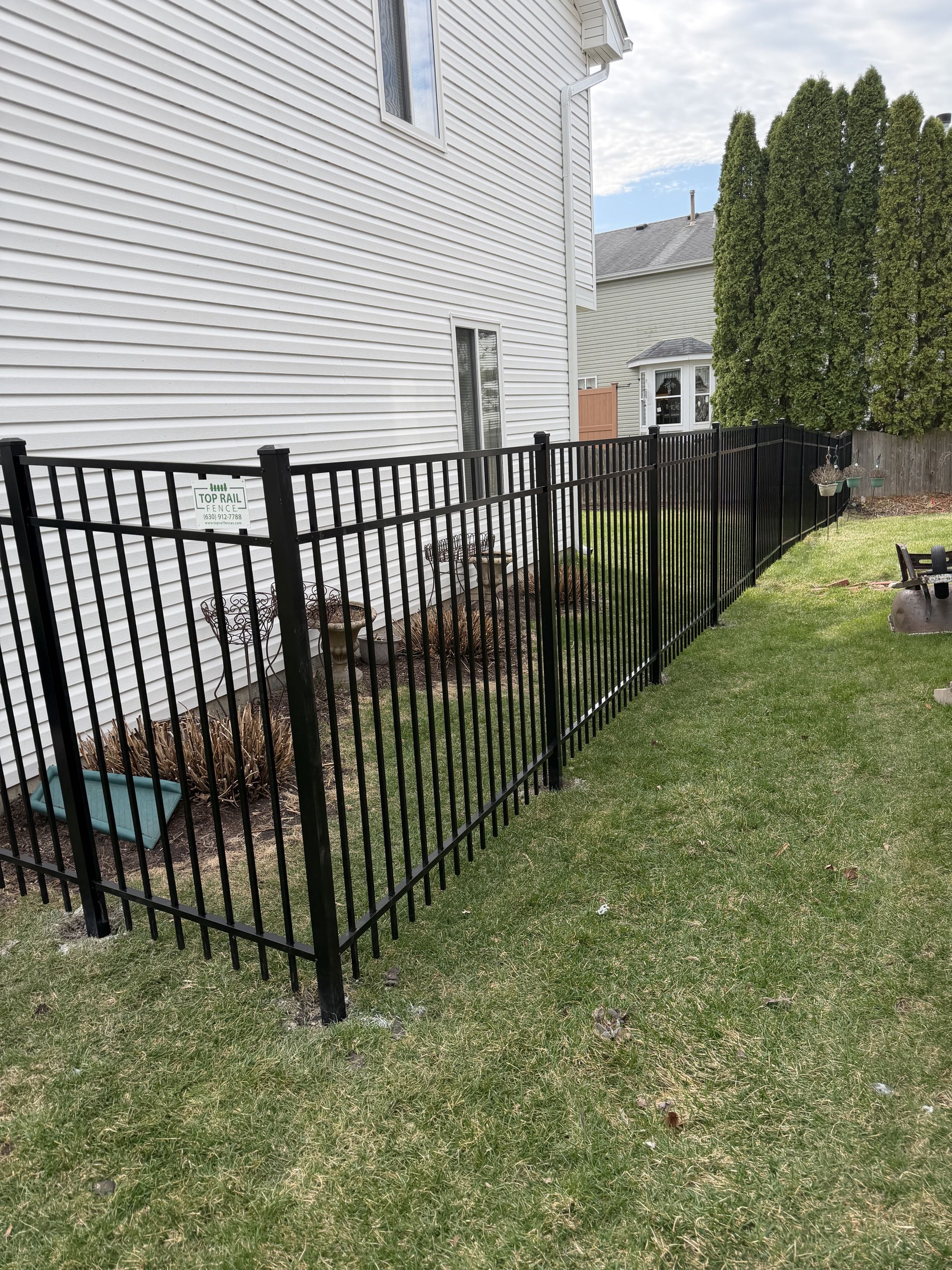 Naperville, IL - A customer requested a secure fencing solution to safely contain their dogs. They opted for a 5-foot tall black aluminum fence, known for its durability and modern appearance. The project involved precise measurements, careful installation of the aluminum posts, and the attachment of high-quality black aluminum panels. Attention to detail ensured the fence was both sturdy and visually appealing, providing the customer with peace of mind and an aesthetically pleasing boundary for their pets. The final result was a robust, reliable fence that met the customer's needs perfectly.