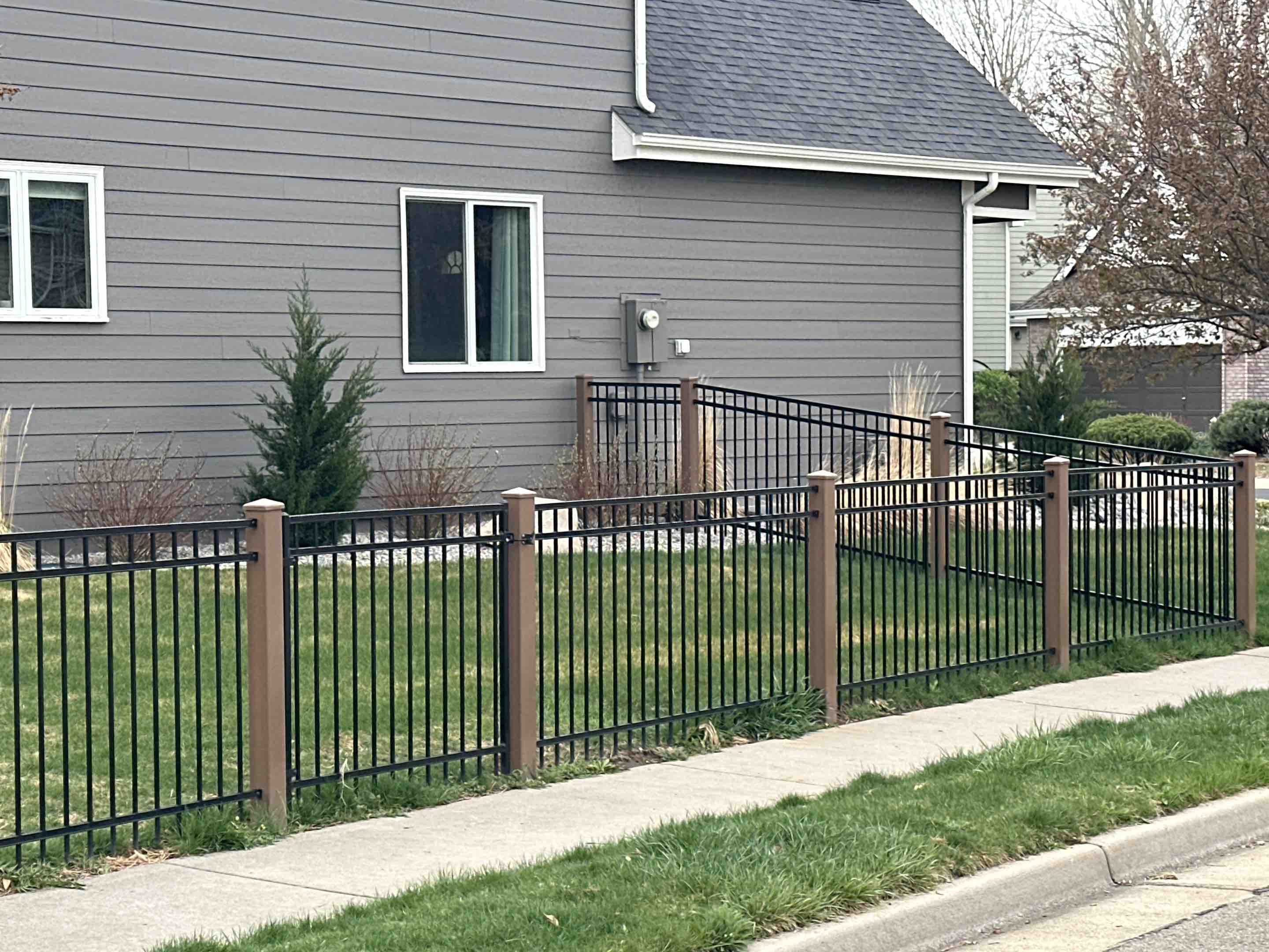 Fort Collins, CO - Beautiful new Ameristar montage fence with tan PVC post. In Fort Collins, Colorado.