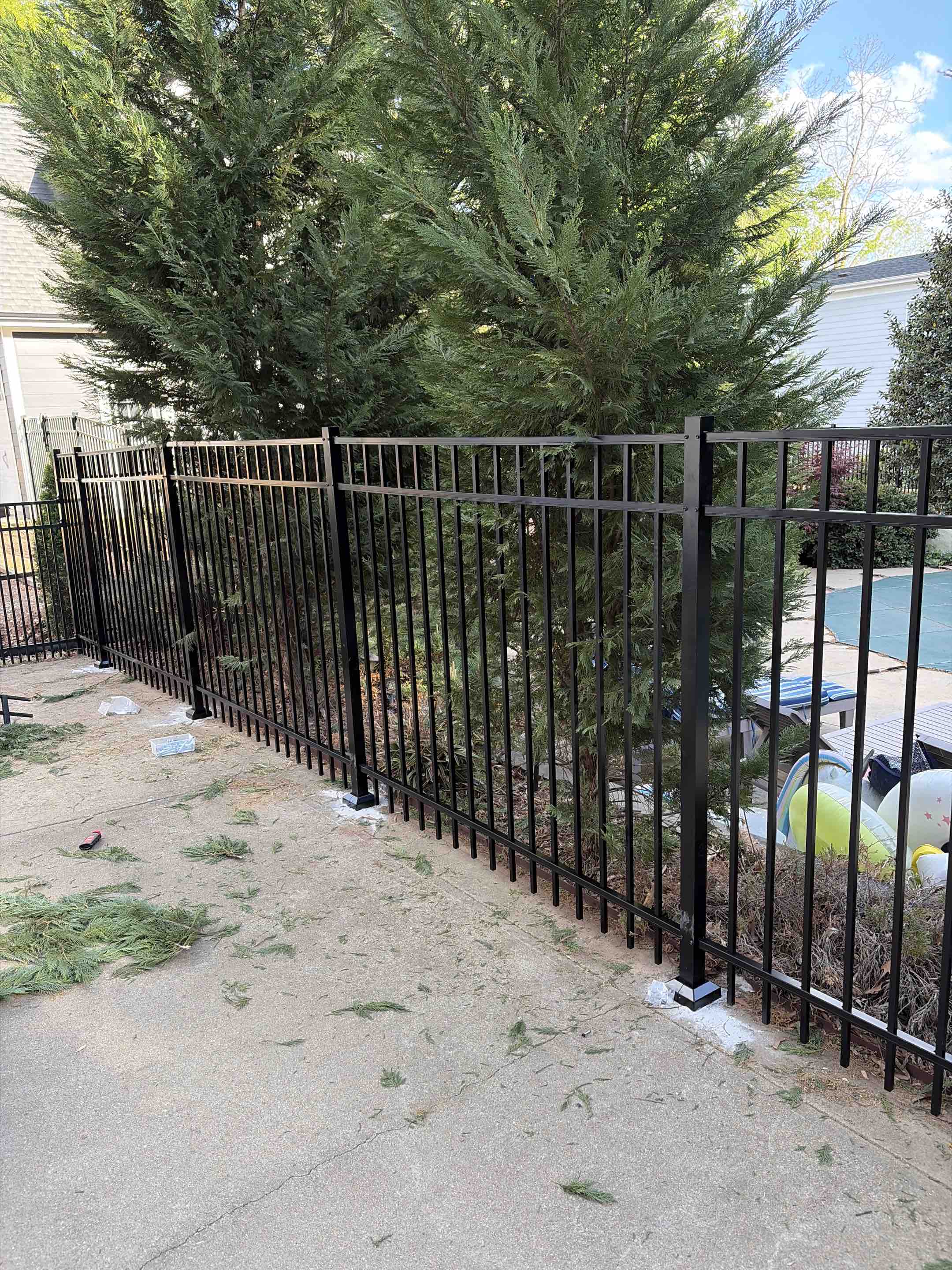 Raleigh, NC - Removed existing fence and installed a 5ft high, 3-rail black aluminum fence to fully enclose the pool area. This new pool enclosure enhances safety, meets code requirements, and adds a clean, modern look while maintaining visibility and durability. Perfect for secure, low-maintenance backyard pool fencing.