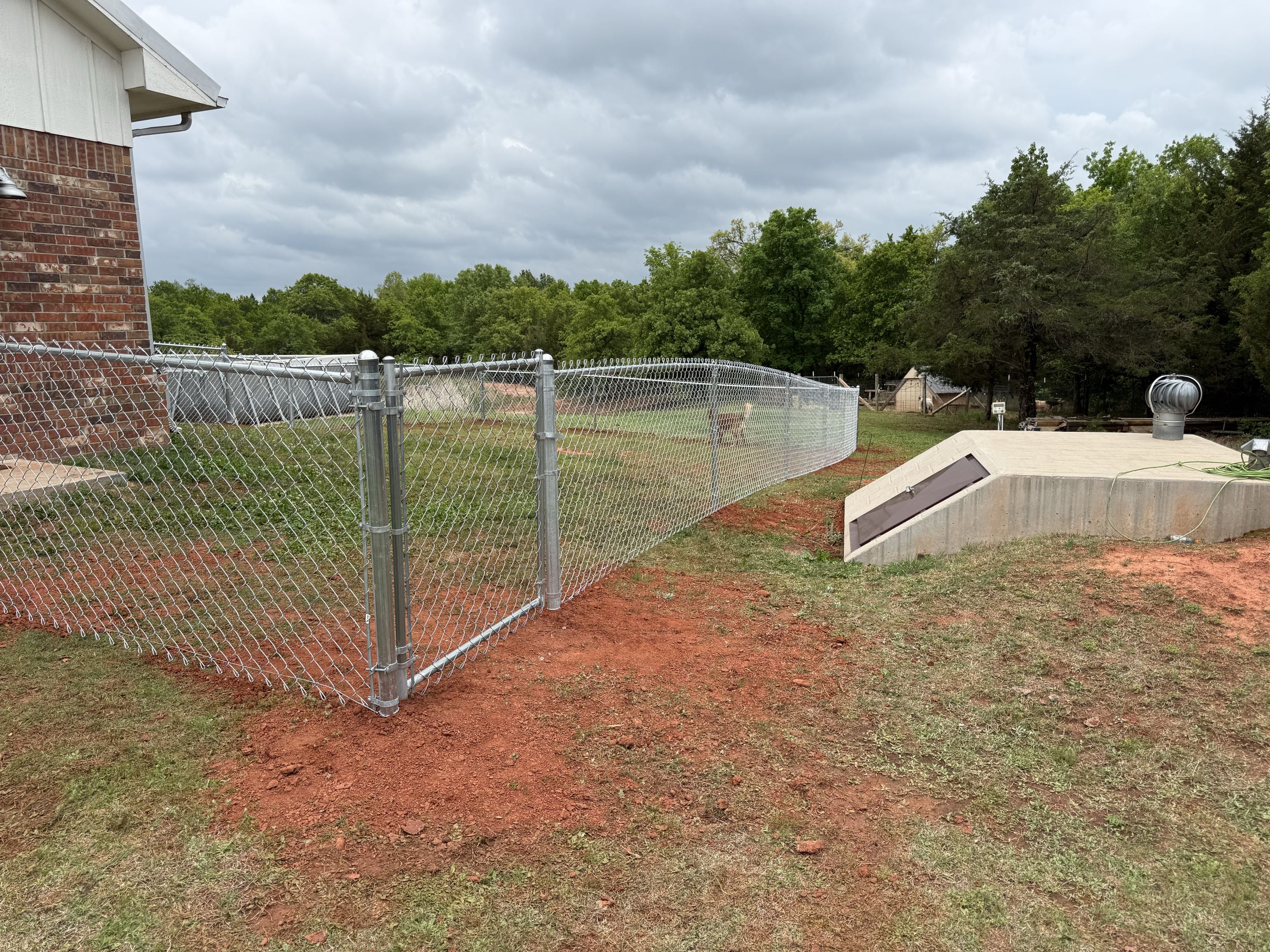 Oklahoma City, OK - Just finished up another beautiful 4 ft tall galvanized chain link fence, giving the dogs a new backyard to enjoy! 