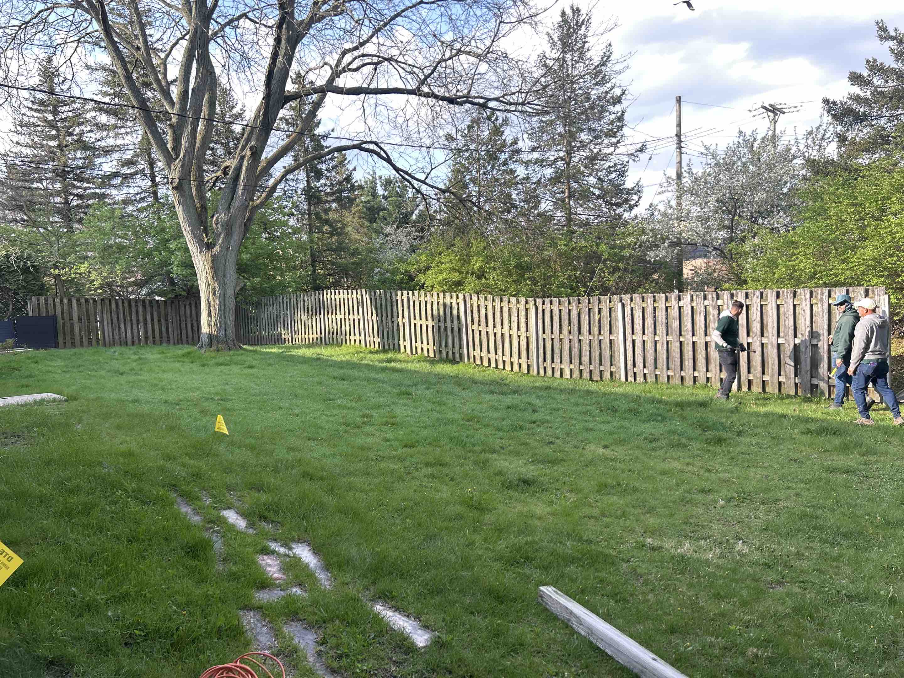 Saline, MI - The team at Top Rail Fence Ann Arbor is tearing down an old shadowbox fence, replacing it with a beautiful new vinyl fence.  This new fence will enhance the beauty and provide more privacy for the home owners