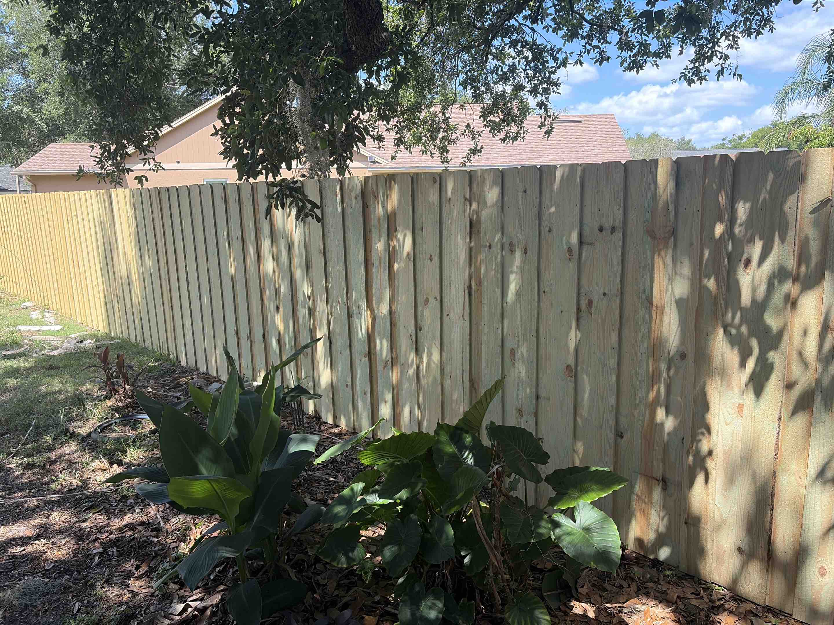 Tampa, FL - A recent project involved the installation of a robust wood fence, designed to provide both strength and privacy. The fence features a board-on-board design, which enhances its durability and offers an additional layer of seclusion. Each board was meticulously measured, cut, and fitted to ensure a seamless and secure installation. The result is a fence that not only stands strong against the elements but also provides an effective barrier for privacy. The natural wood finish complements the surrounding environment, adding both aesthetic appeal and functional benefits to the property.