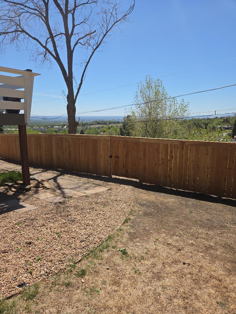 Lakewood, CO - This 5'H  high Cap and Trim privacy cedar fence looks looks stunning against this mountain top back drop. call us for free estimate!