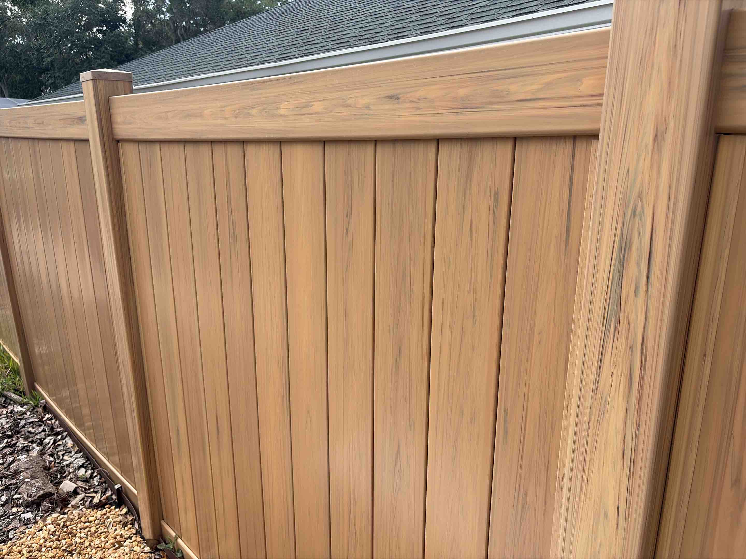 Lutz, FL - I meticulously crafted a wood grain vinyl fence, blending the timeless appeal of natural wood with the durability and low maintenance of vinyl. Each panel was carefully installed to ensure a seamless, elegant appearance, providing optimal privacy while preserving the aesthetic charm of a traditional wooden fence. The project involved precise measurements, expert cutting, and secure fastening to create a robust structure that withstands the elements. The final result is a fence that not only enhances the property's privacy but also adds a touch of natural elegance, making it a perfect choice for those who appreciate both form and function.