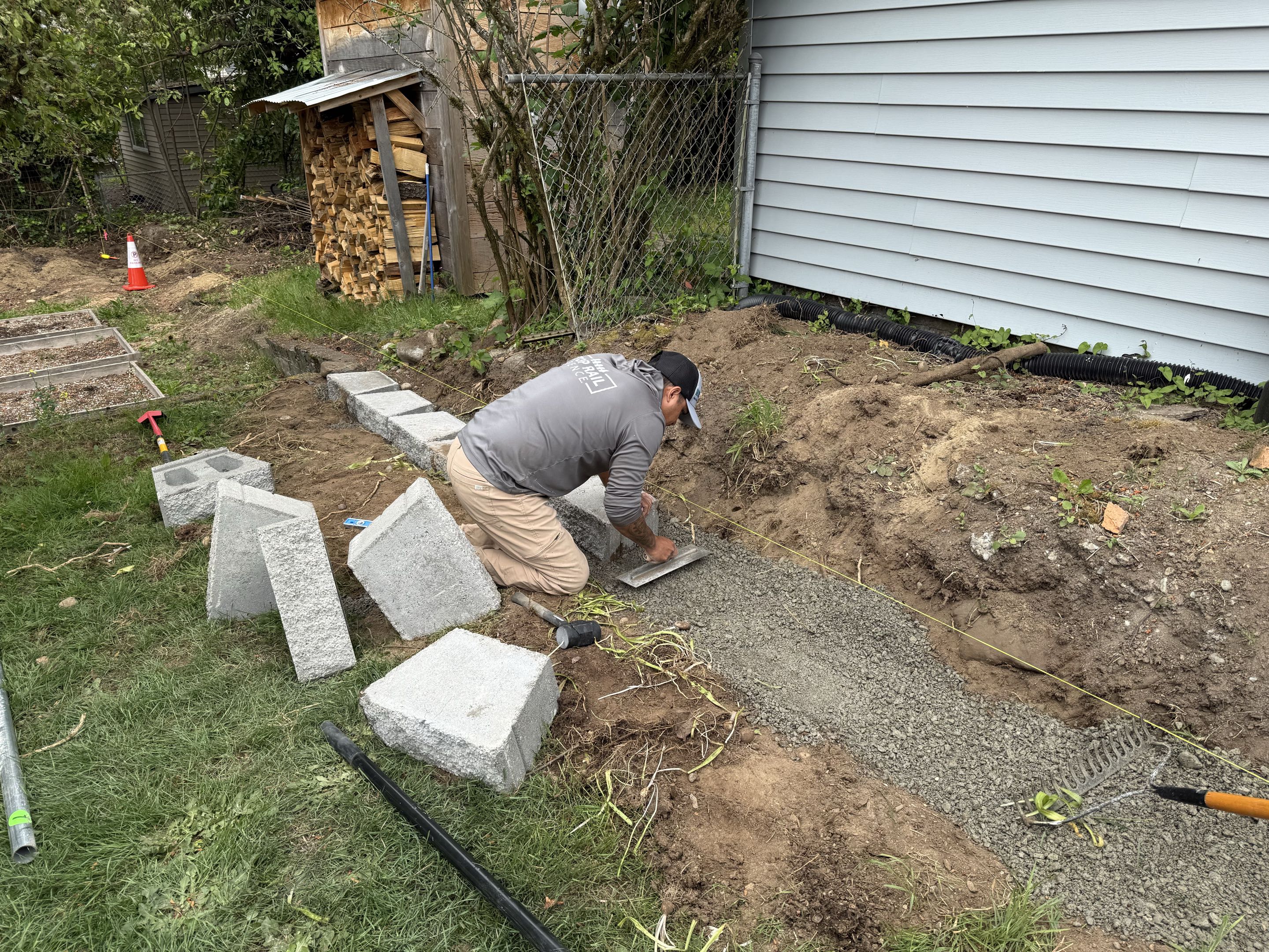 Seattle, WA - Sometimes we build retaining walls under fences. This one is in Northgate.