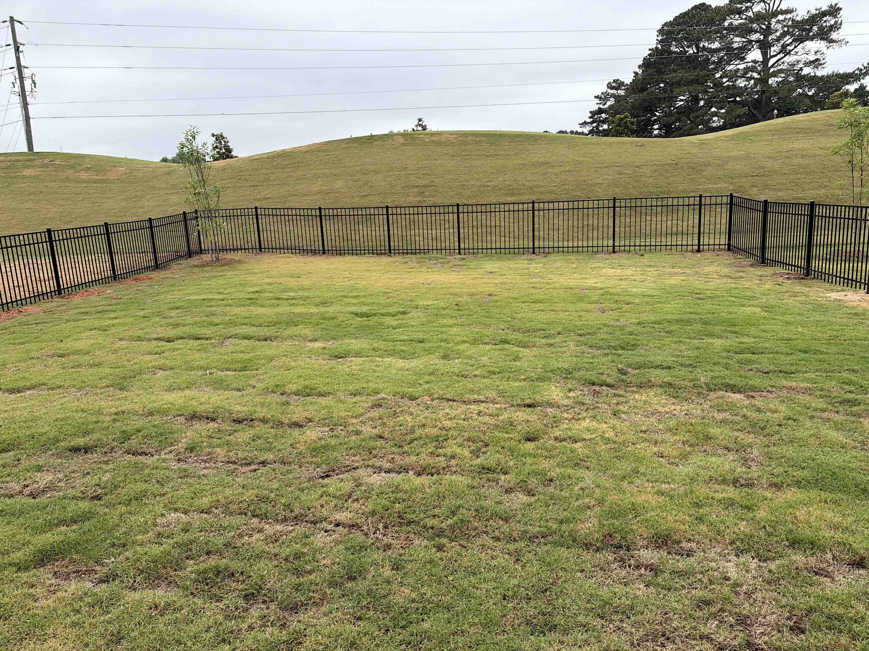 Garner, NC - We installed 190 linear feet of a sleek, 3-rail flat top black aluminum railing system, standing 4 feet high.Each section was securely anchored to provide maximum stability and safety. A single gate was integrated into the design, allowing for easy access while maintaining the integrity of the fence. The final result is a durable, aesthetically pleasing fence that enhances both safety and style.