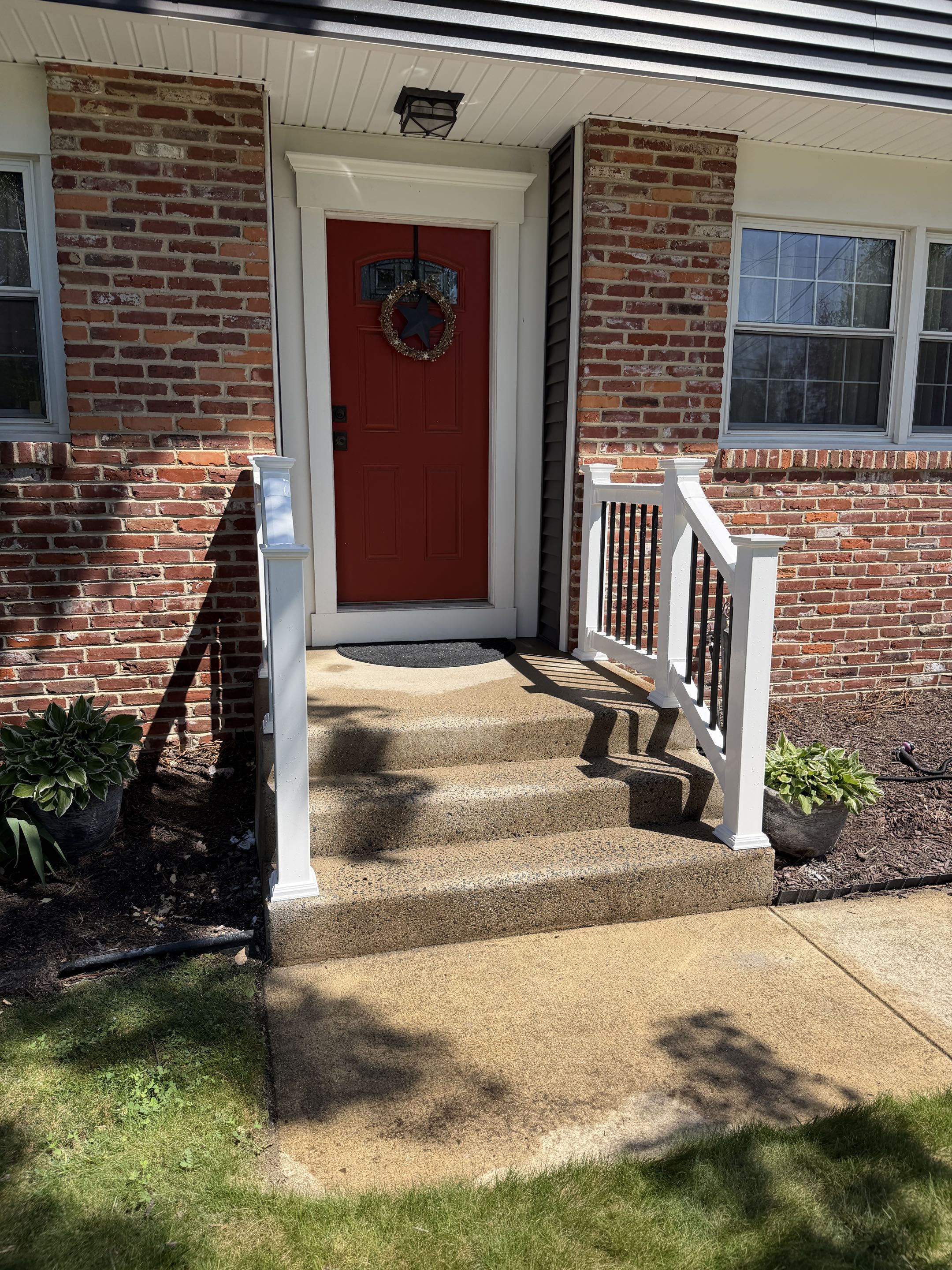 Cherry Hill Township, NJ - Front and back porch white vinyl with aluminum spindles railing installed in Cherry Hill.