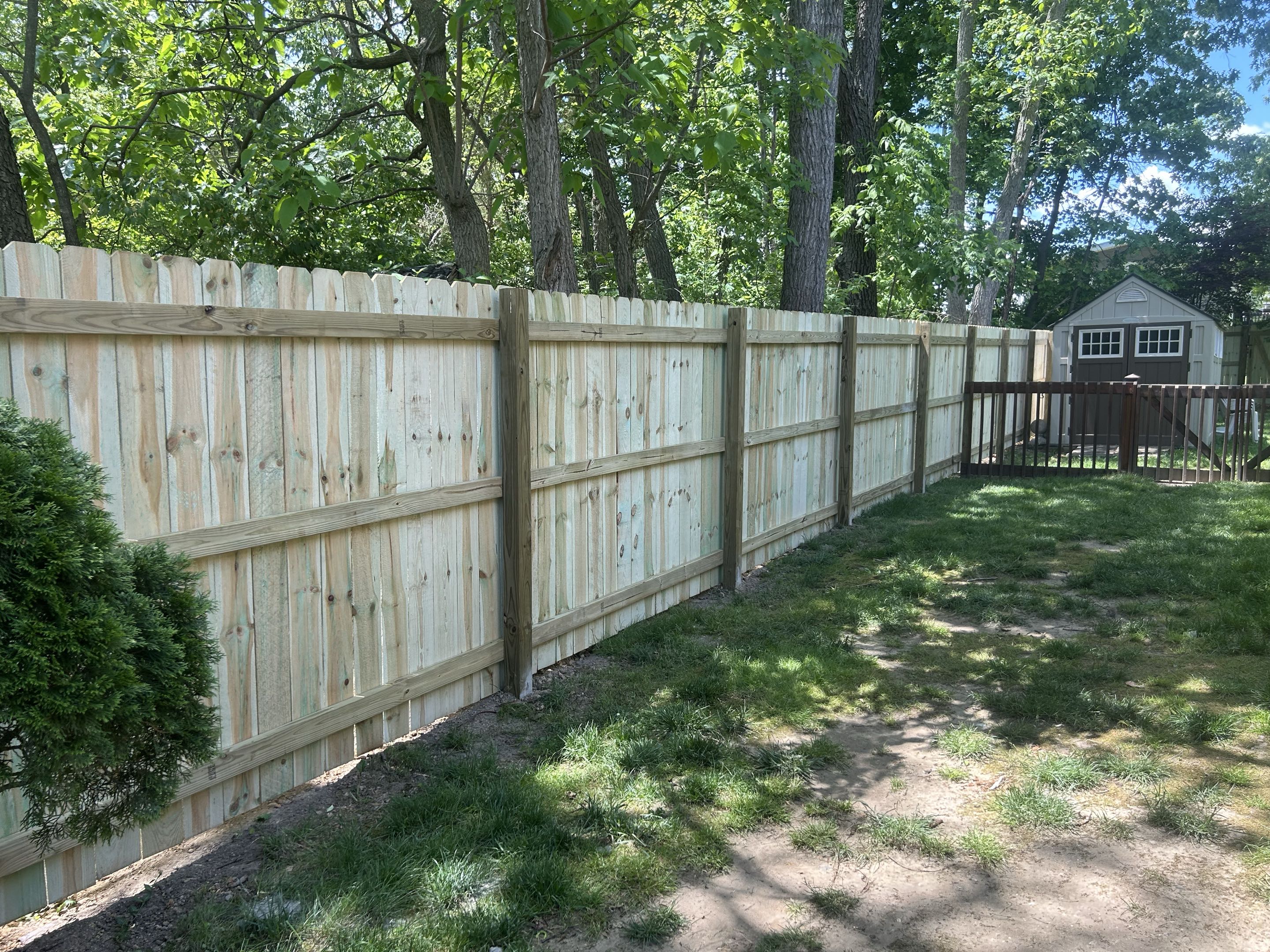 Brighton, MI - Top Rail Fence in Arbor just completed this wood dog gear privacy fence near Brighton, Michiga. Wood is an affordable option for security and beauty.  Customer is very happy with the results.