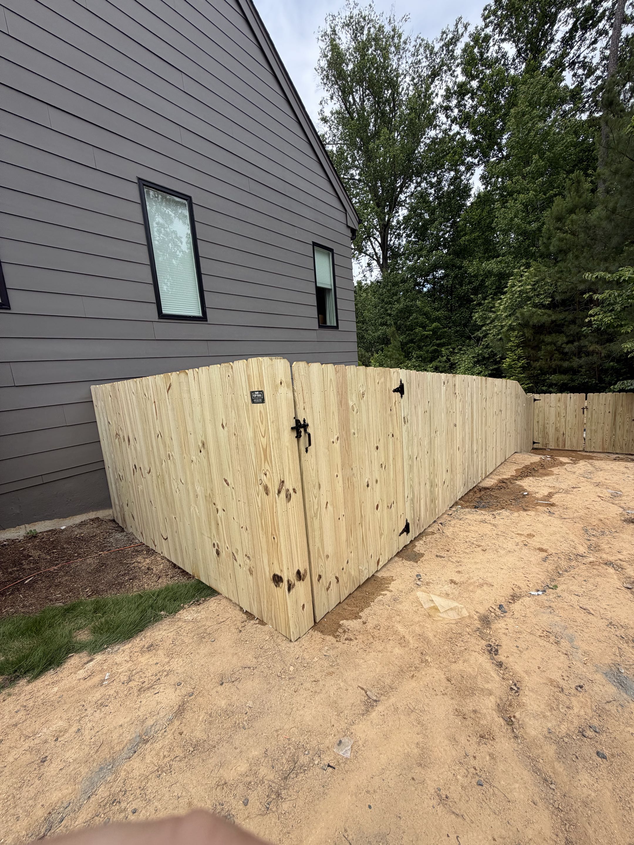 Chapel Hill, NC - Transform your backyard into the ultimate retreat! We just completed this stunning 265’ x 6’ high dog-ear wood privacy fence, designed to be both beautiful and secure. With two custom walk gates and a double gate that fully meets strict pool safety codes, your family and furry friends can now enjoy the water with total peace of mind. A perfect, safe haven for summer fun and relaxation. Ready to secure your oasis? #PoolSafety #BackyardDesign #CustomFence #PetFriendly #HomeImprovement #DreamYard