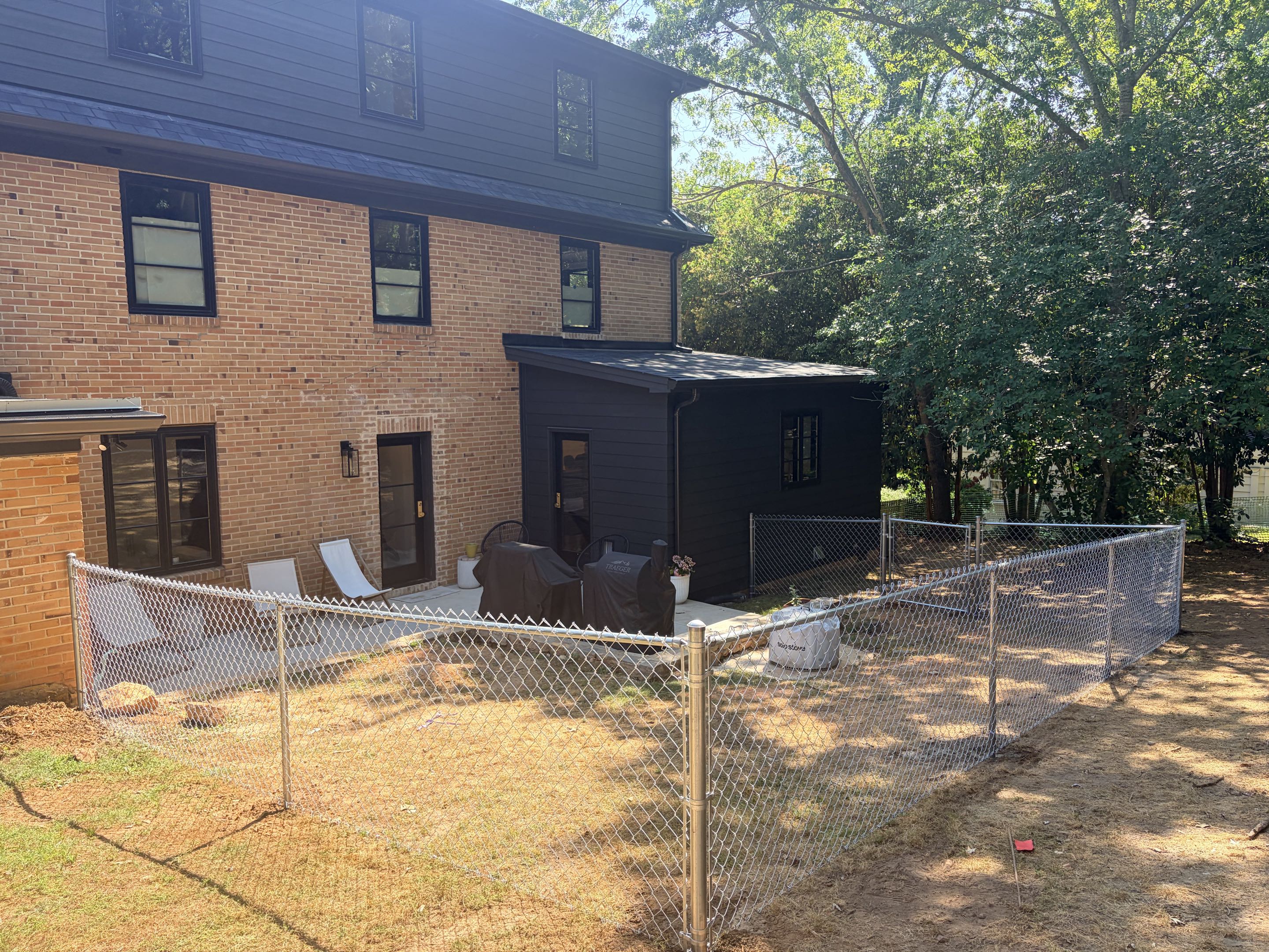Raleigh, NC - A new chain link fence was installed to create a safe and spacious play area for the dog. The fence was built using top-quality materials, ensuring durability and longevity. Standing at 4 feet, it provides ample space for the dog to run and play while keeping it securely within the designated area. The final result is a reliable and functional fence that perfectly meets the needs of both the dog and the owner.