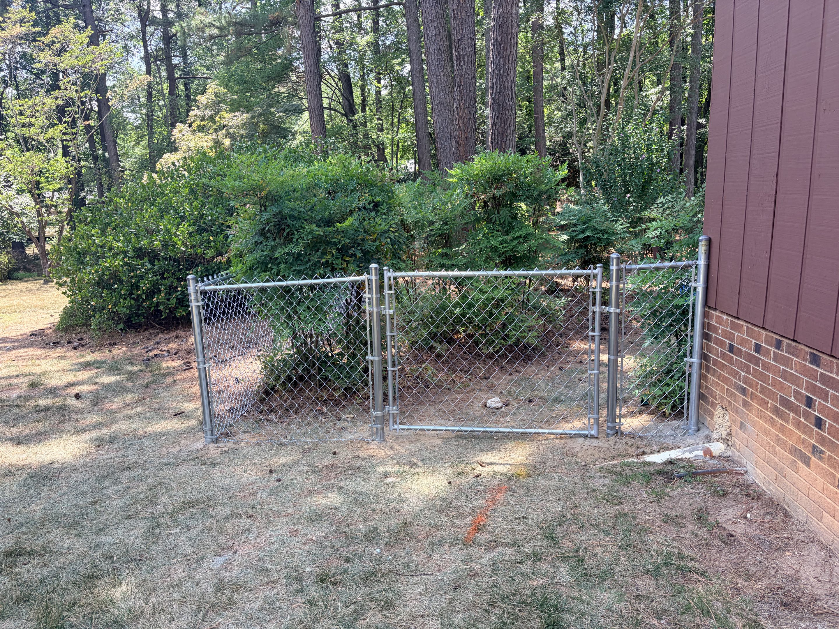 Raleigh, NC - A 150-foot stretch of 4-foot-high galvanized chain link fencing and two gates were meticulously installed, ensuring a secure and durable perimeter. Each post was anchored firmly into the ground with concrete, and the chain link was carefully attached, ensuring a tight and even weave throughout. The final result was a robust and visually appealing fence that met the customer's needs perfectly. The customer's satisfaction was evident, reflecting the quality of the work performed.