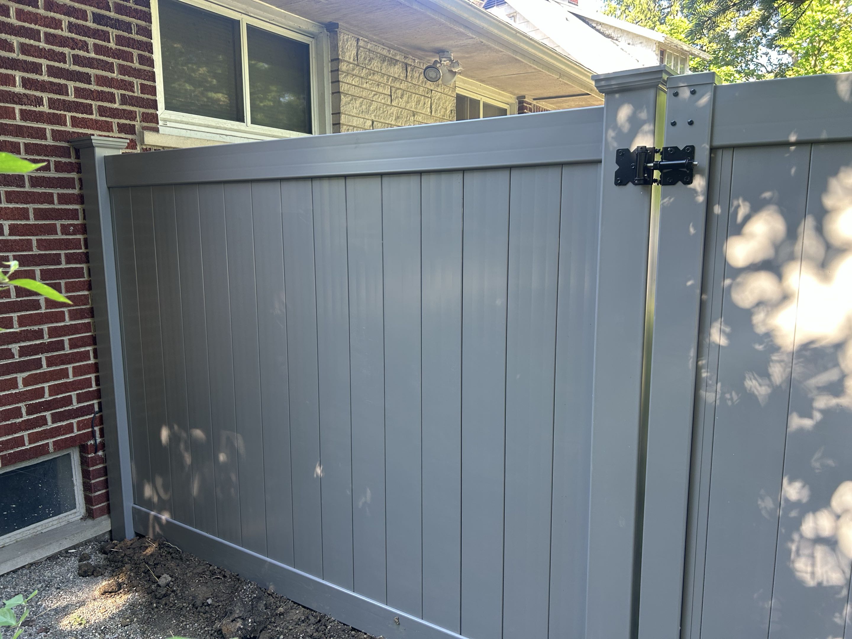 Ypsilanti, MI - Last year Top Rail Fence Ann Arbor did a Fence off of Washtenaw Ave near Eastern Michigan University. The neighbor called wanting the same.  We finished 130 ft of this Gray Vinyl fence to match in a day