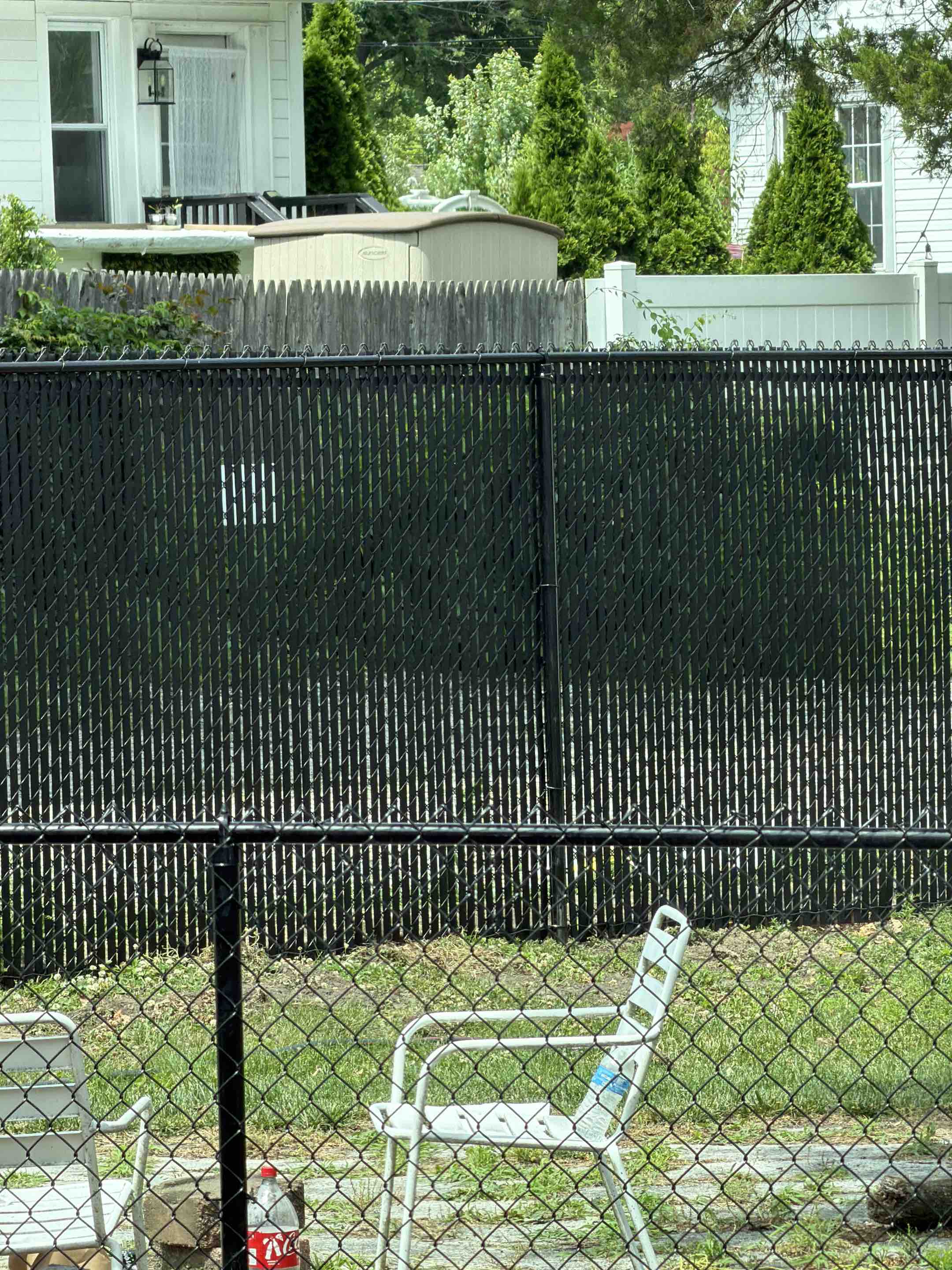 Haddonfield, NJ - Black chain link installed with privacy slats.
