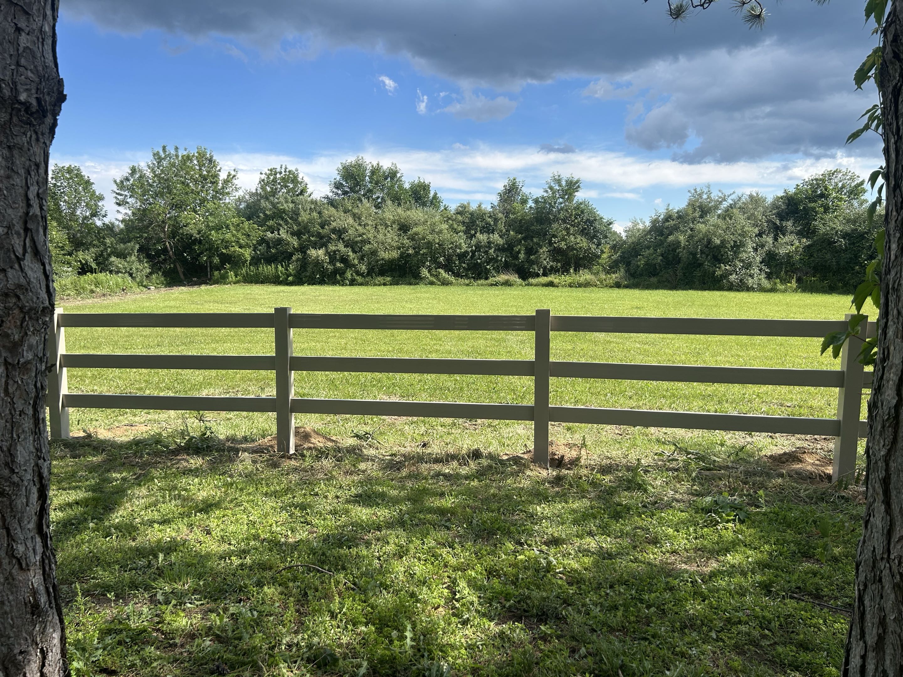 Dexter, MI - Top Rail Fence Ann Arbor is in Dexter Michigan off of Jackson Road. We are replacing an old wood ranch trail fence with a new modern vinyl fence. This adds flavor to the farm while also protect protecting the horses.