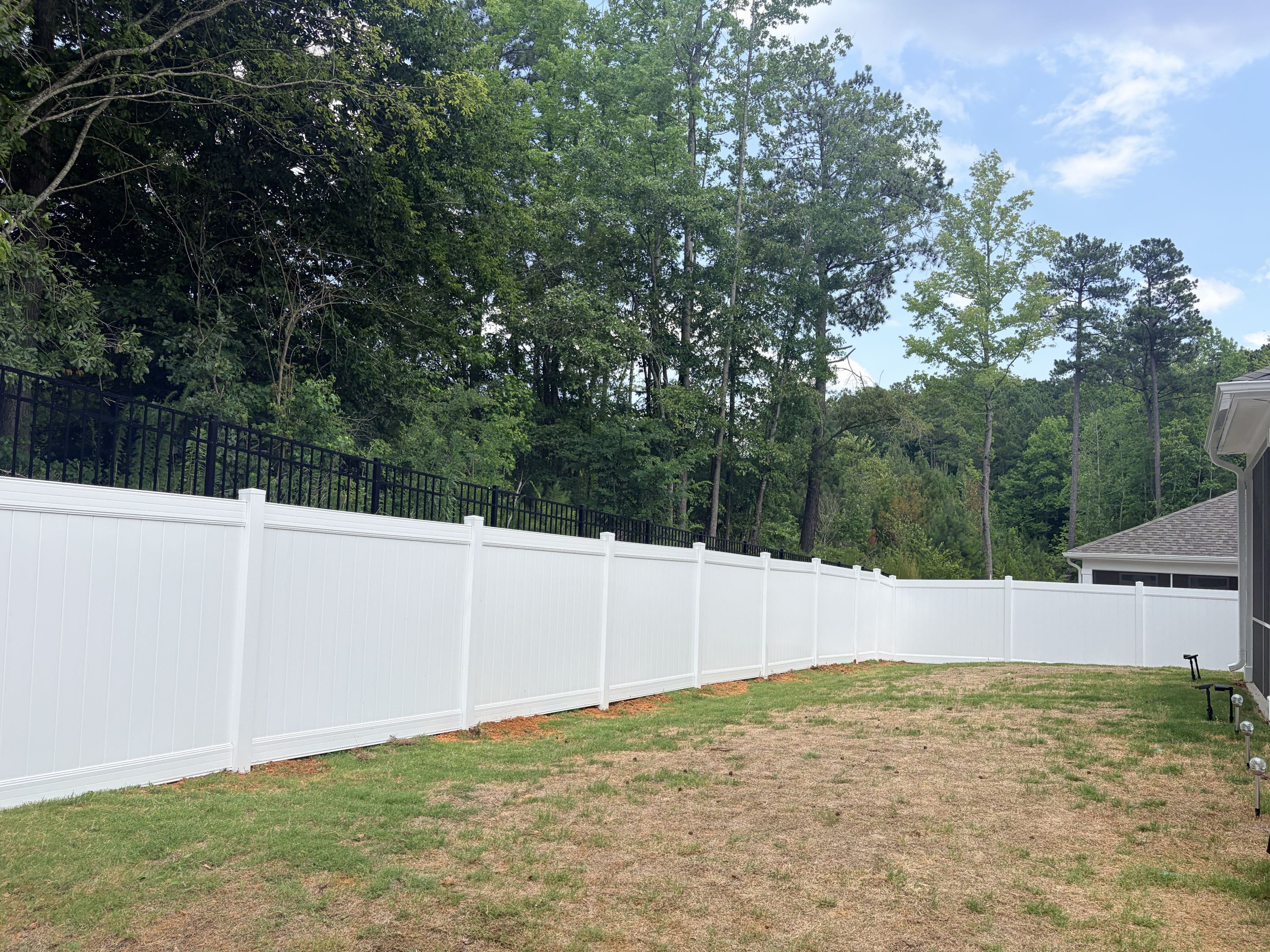 Clayton, NC - Completed a project involving the installation of 200 linear feet of 6-foot high white vinyl privacy fencing for a new residential build. The vinyl material was chosen for its durability and low maintenance. A 5-foot wide gate was included to provide convenient access while maintaining privacy. The fencing was designed to enhance curb appeal and ensure safety for a dog, creating a secure environment. The installation was meticulous, ensuring a seamless and aesthetically pleasing result.