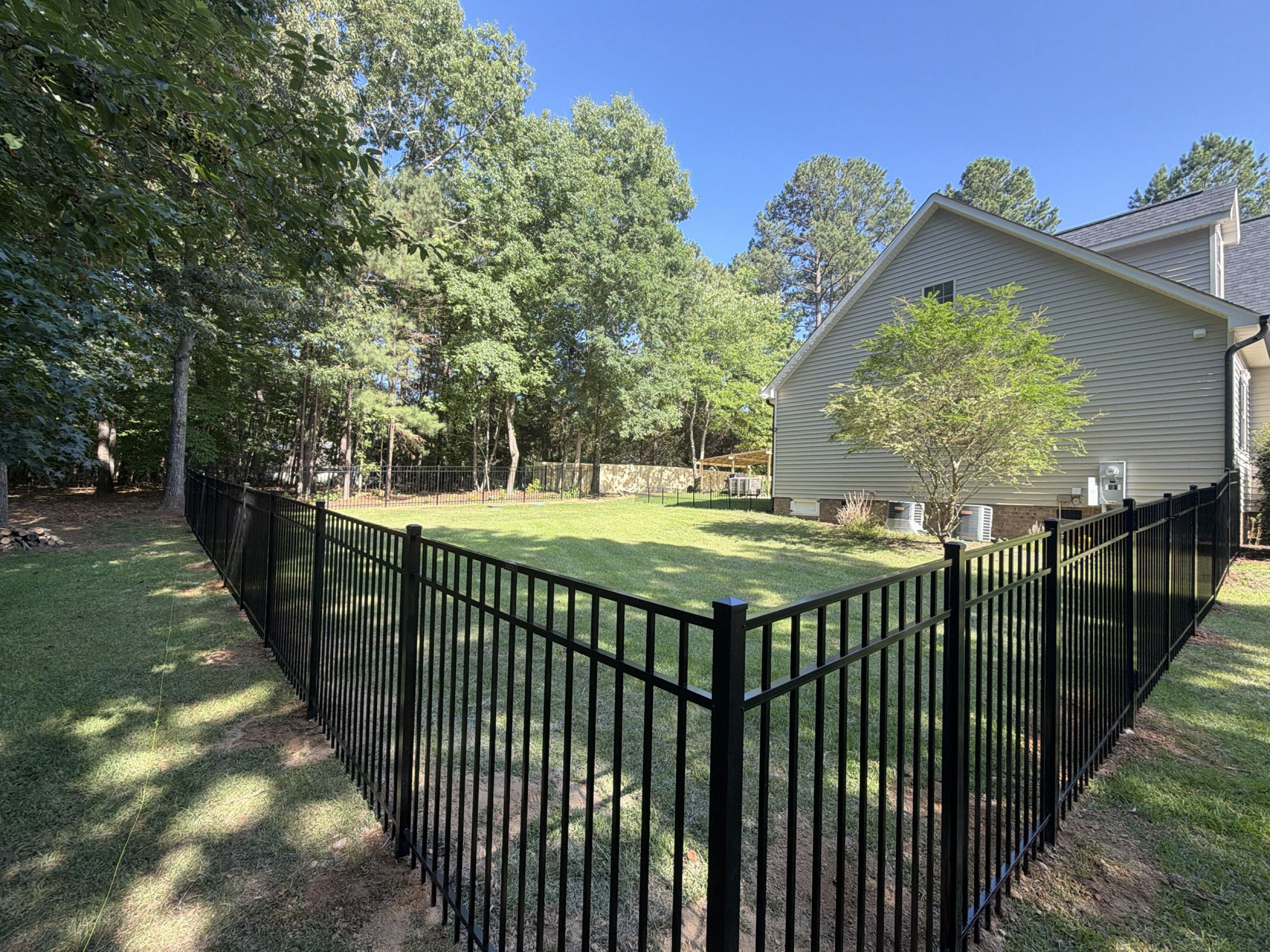 Wake Forest, NC - We just completed a dual-material backyard enclosure in Wake Forest, NC! To give the homeowner a perfect blend of open views and premium privacy, we installed 300 linear feet of 5-foot-tall, 3-rail aluminum fencing alongside 140 linear feet of 6-foot-high wood board-on-board privacy fencing. The project features one single gate and one double gate for easy backyard access and maximum security. #TopRailFence #TopRailFenceRDU #VeteranOwned #WomanOwned #LocallyOwned 
