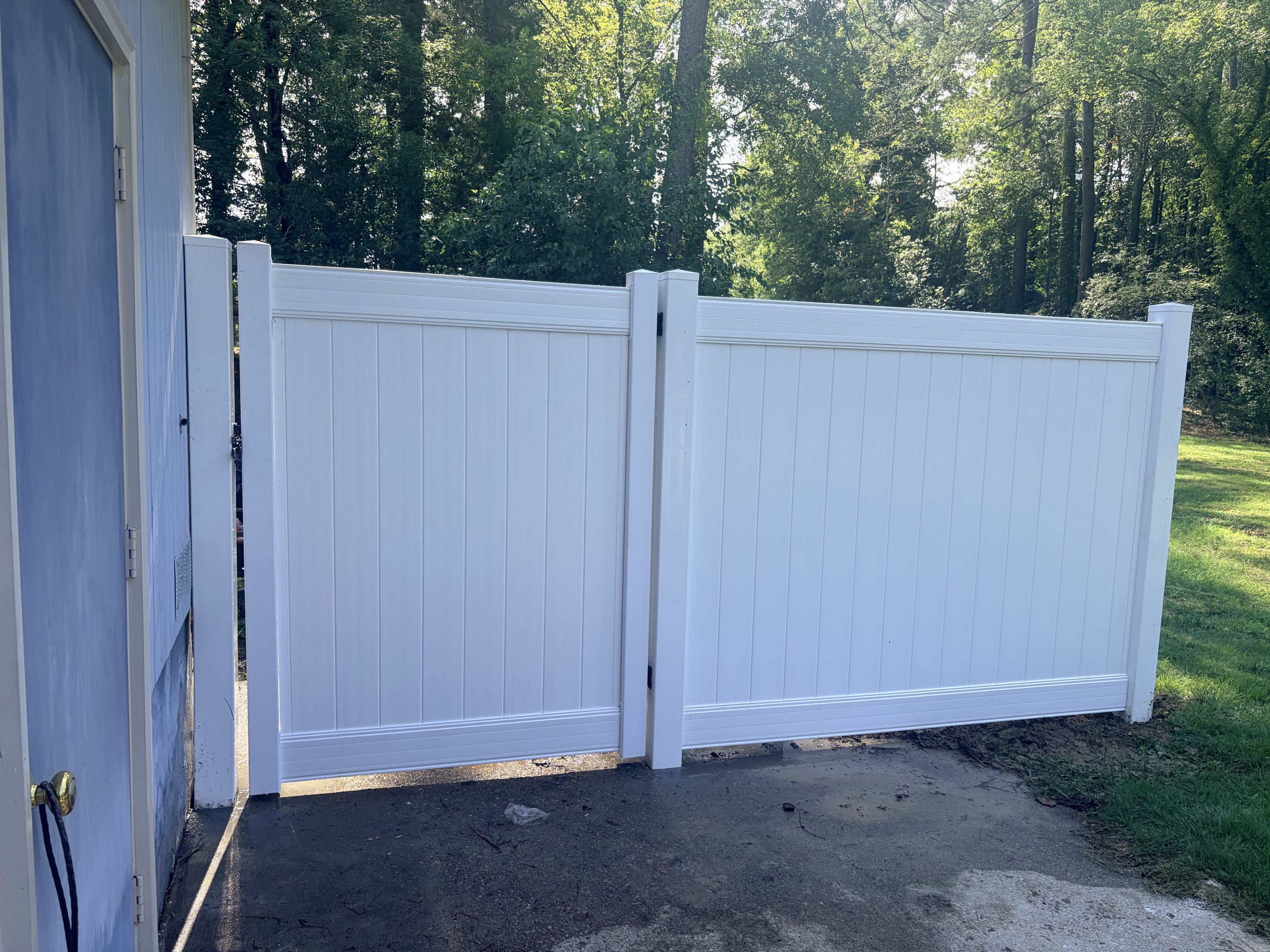 Raleigh, NC - We replaced a deteriorating wooden fence with a new 6-foot high white vinyl privacy fence. Using a core drill, we placed the fence posts securely into the paved driveway, ensuring stability and enhancing curb appeal. The vinyl material was chosen for its durability and low maintenance. The fence installation was completed with precision, providing increased privacy and security for the property. The job was finished on time, leaving the area clean and tidy.