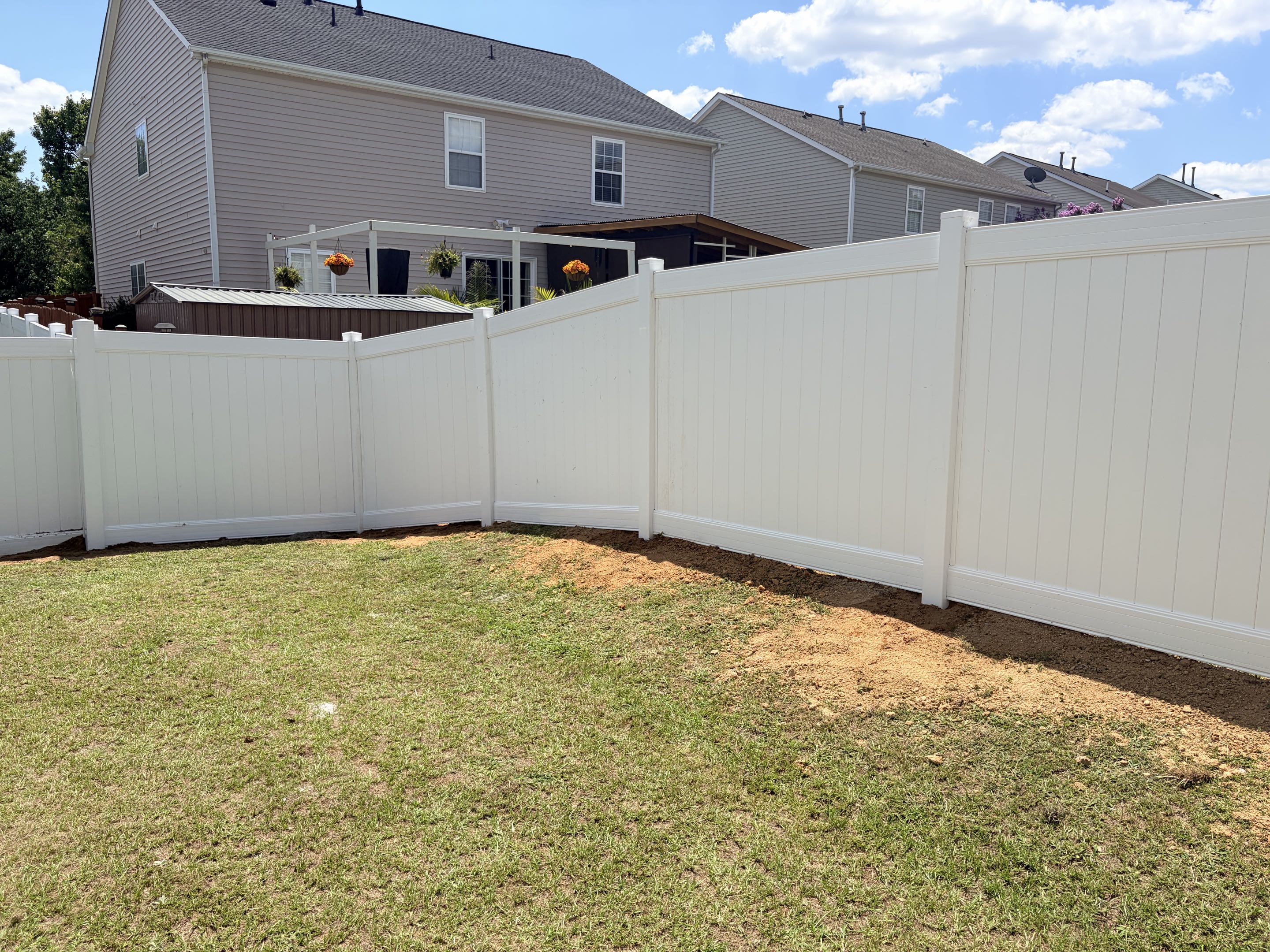 Raleigh, NC - Our team meticulously installed 150 linear feet of a 6-foot-tall white vinyl privacy fence, ensuring a secure and private backyard environment. A double gate was incorporated to allow easy access while maintaining the fence's integrity. This installation was designed to keep children safe and prevent pests from entering the backyard, enhancing both safety and comfort for the family. The project was completed with precision, ensuring a seamless and aesthetically pleasing result.