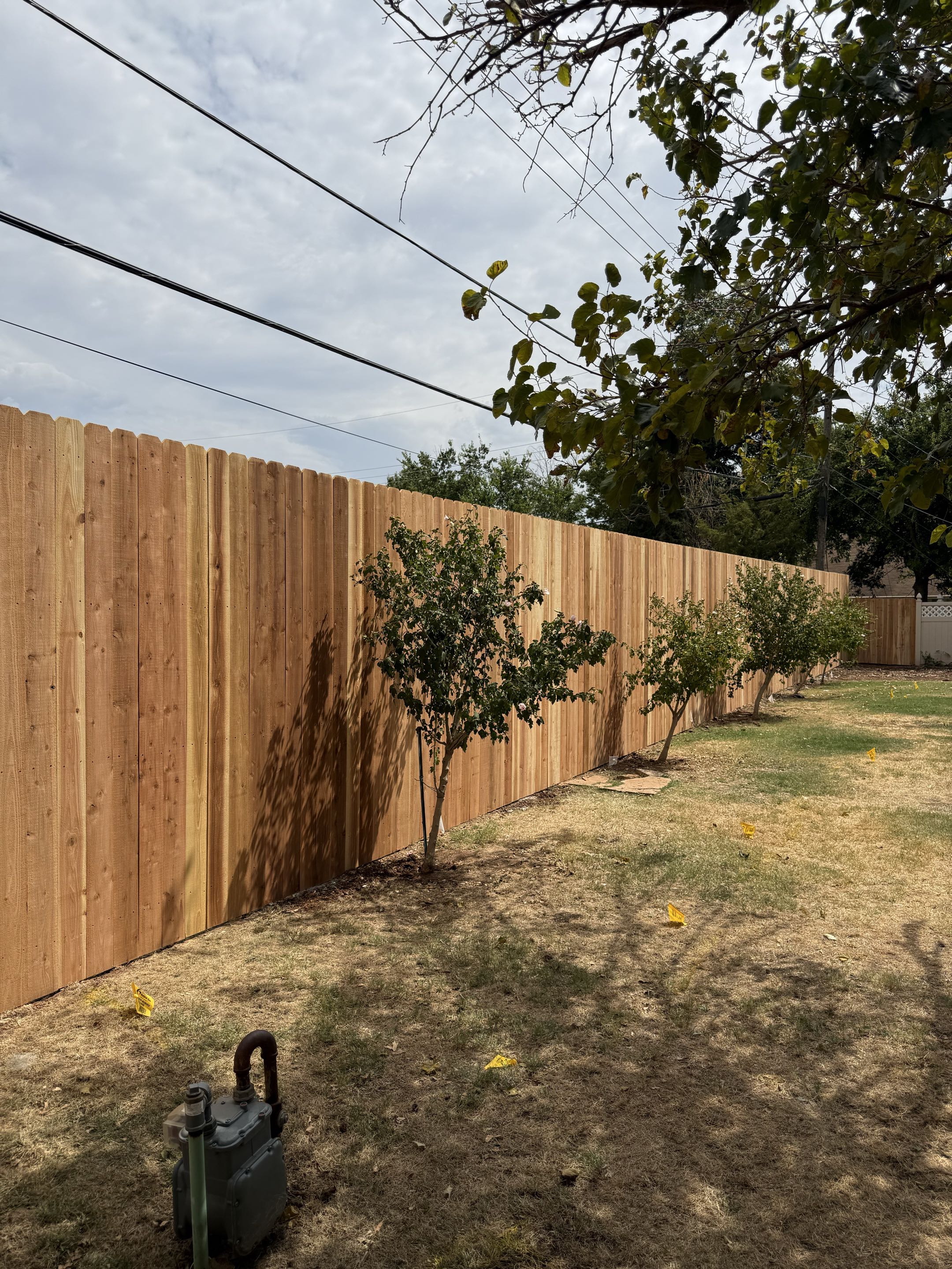 Oklahoma City, OK - Tore down and replaced the existing fence with a beautiful 8 ft tall Japanese cedar privacy fence, tapering down to 6 ft for a clean, natural transition. The finished fence gives the property a fresh, upgraded look while providing excellent privacy and durability.