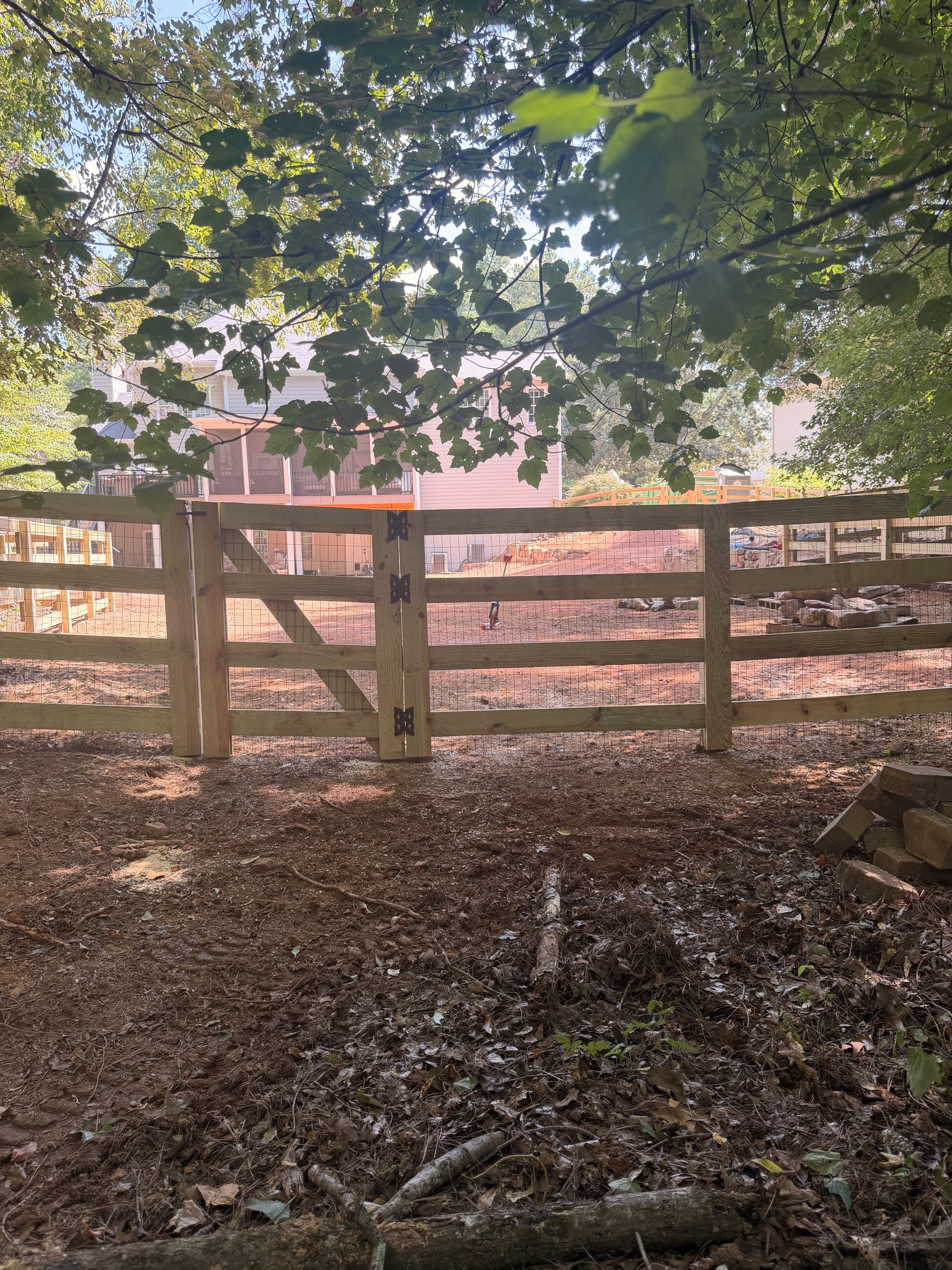 Cumming, GA - 350 LF • 5’ High • 4-Rail Ranch Rail with Black Wire Mesh  Recently completed 350 linear feet of 5-foot-high, 4-rail ranch rail fencing with black wire mesh, providing a clean, durable enclosure while maintaining the open look of the property.