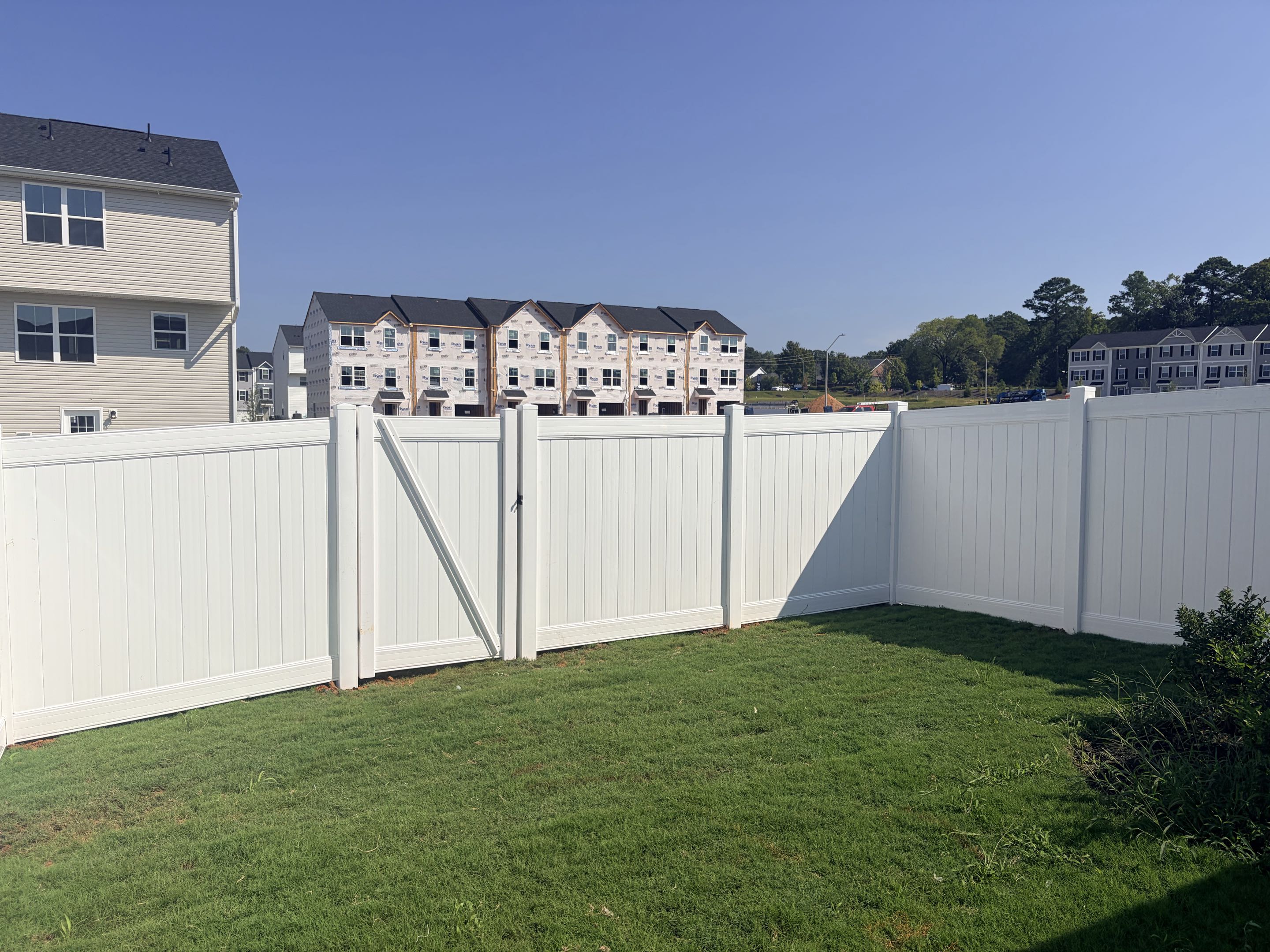 Raleigh, NC - We meticulously installed 50 feet of a 6-foot high white vinyl privacy fence, ensuring a seamless blend of durability and aesthetics. Each section was precisely measured and cut to fit perfectly, providing optimal privacy and security. The fence features a single gate, designed for easy access while maintaining the fence's integrity. This installation not only enhances the property's appearance but also creates a safe space for their dog to roam freely without worry. The high-quality vinyl material guarantees long-lasting protection against the elements, ensuring the fence remains in excellent condition for years to come.